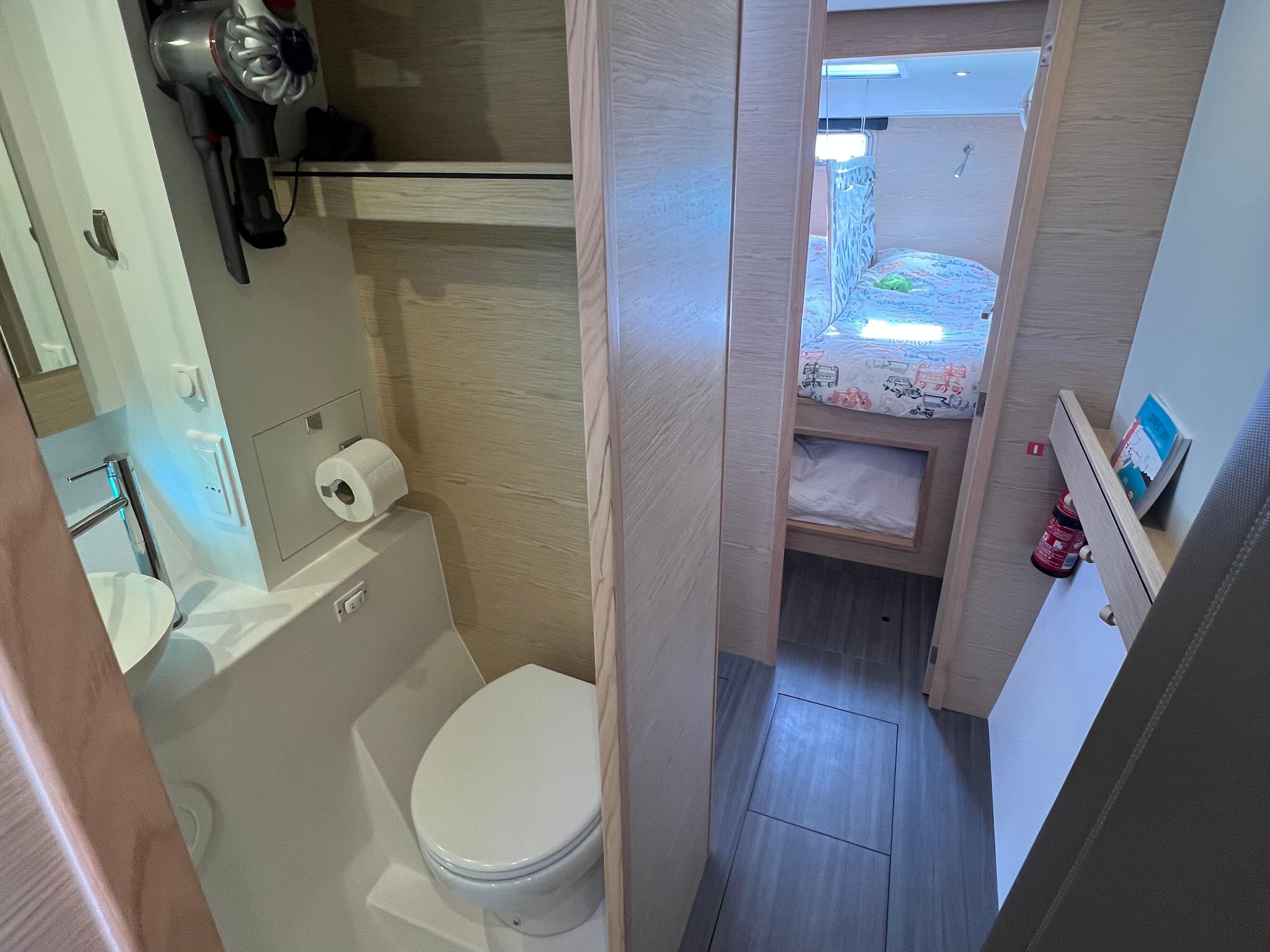 2024 Outremer 45 yacht interior with bathroom and cozy cabin view.