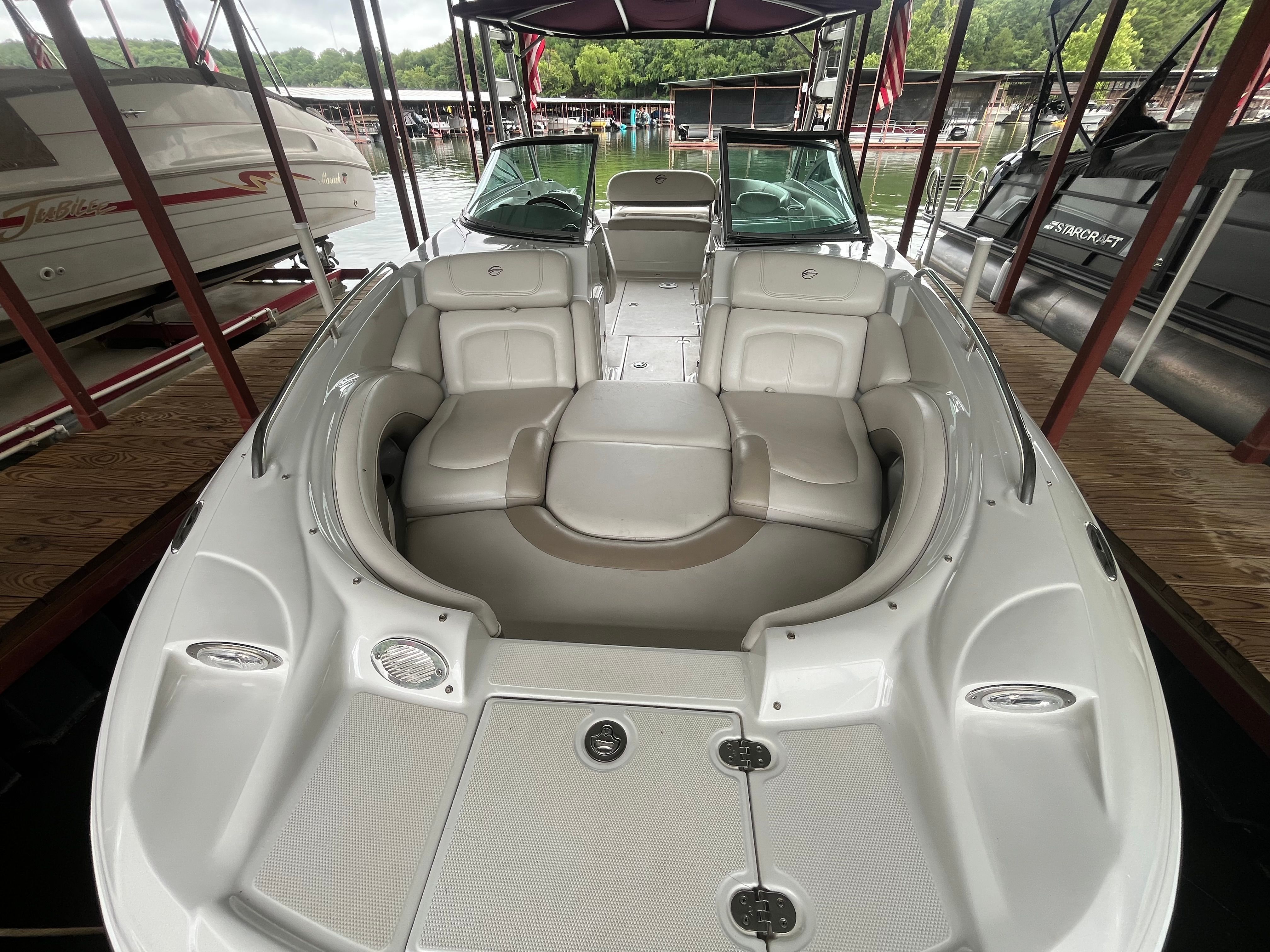 The image shows a 2008 Crownline 252EX boat docked in a marina.