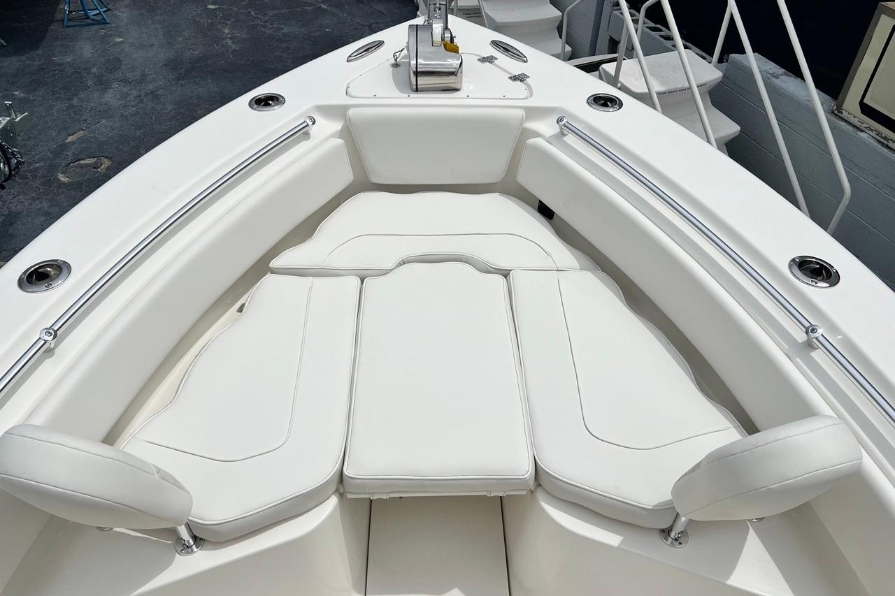 2026 Key West 239 FS boat with white cushioned seating and stainless steel railings.