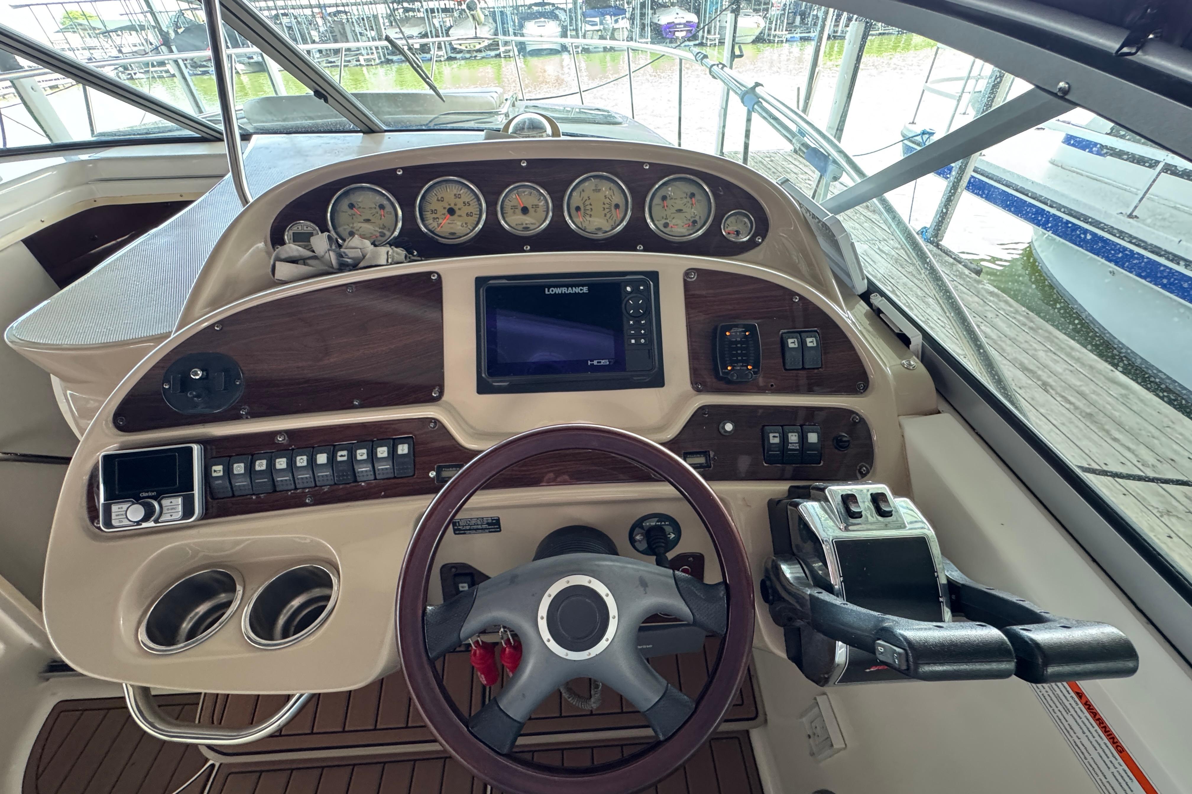 Cockpit of 2006 Chaparral 330 Signature boat with steering wheel and control panel.