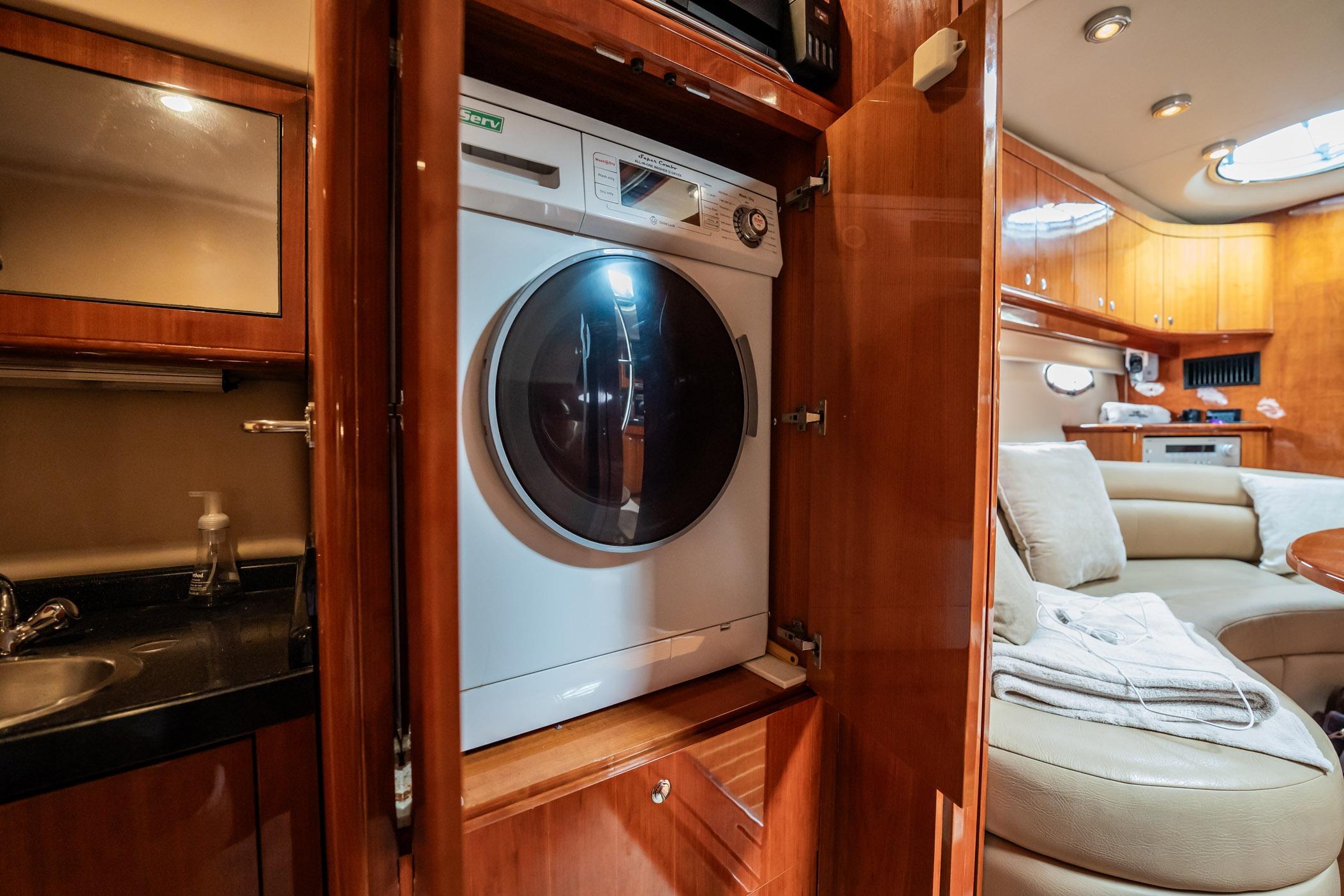 2008 Regal Commodore 4460 yacht interior with washer, luxurious seating, and wooden cabinetry.