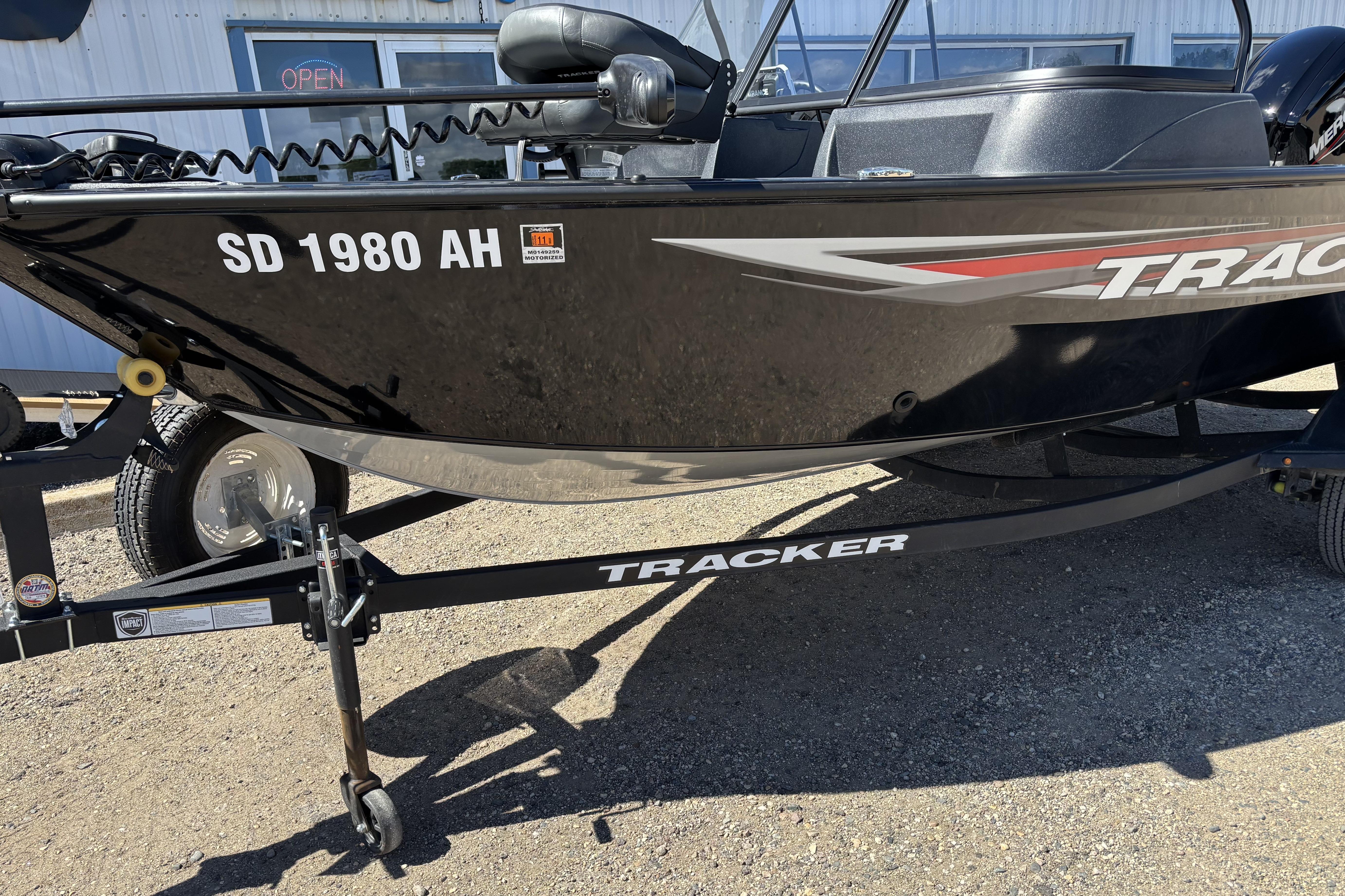 2026 Tracker Pro Guide V-16 WT boat on trailer, parked outdoors.