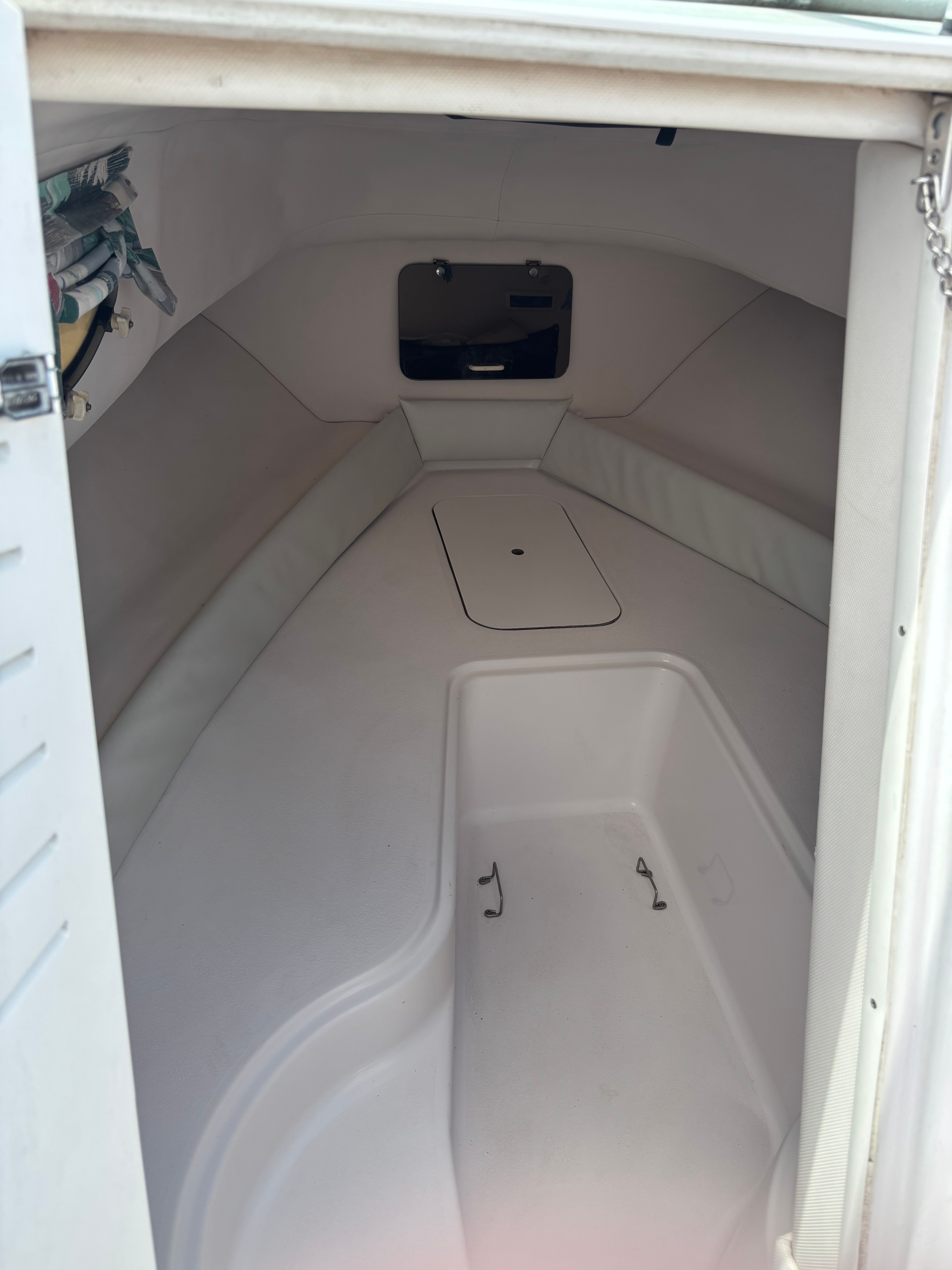 Interior of a 1999 Pro-Line 221 Walk Around with seating area and storage.