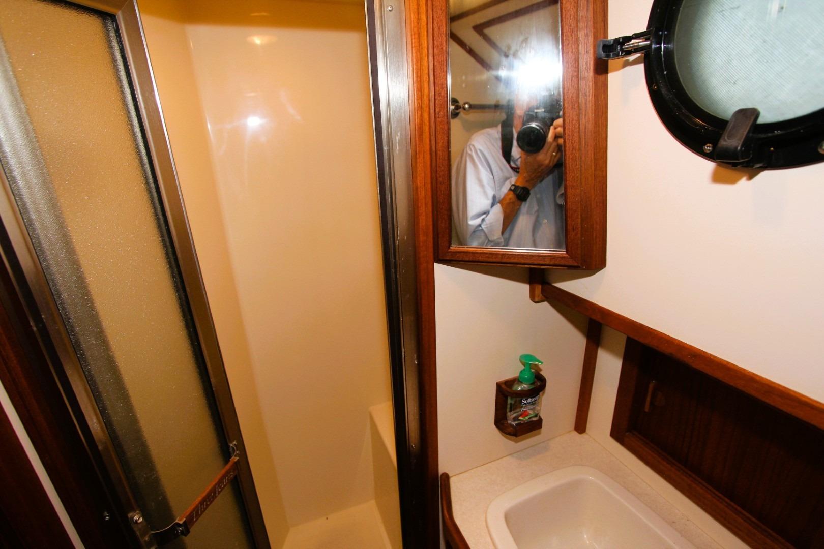 Bathroom interior of 2002 Nordic Tug 37 with shower and sink.