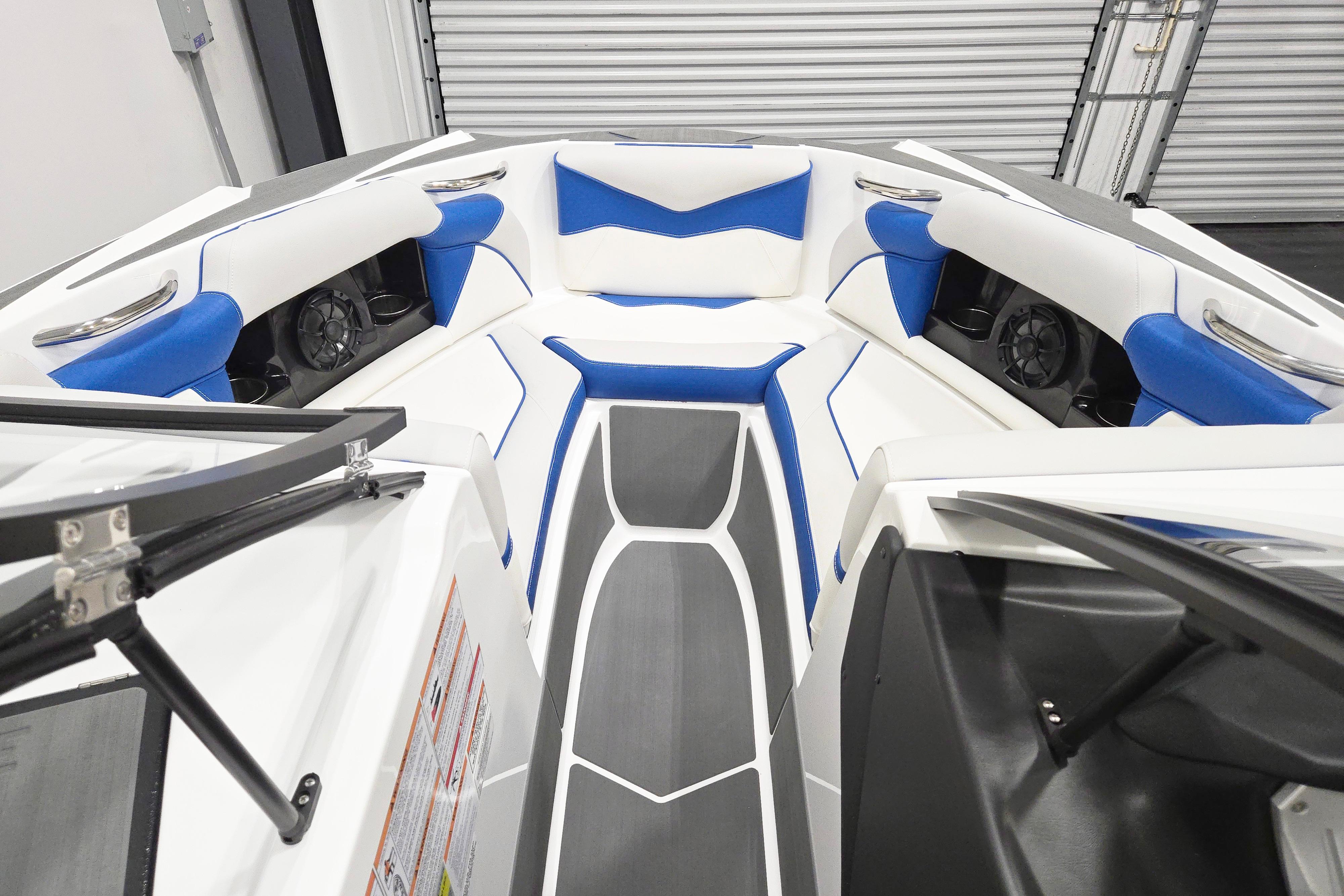 2026 Supreme S220 boat interior with blue and white seating, modern design.