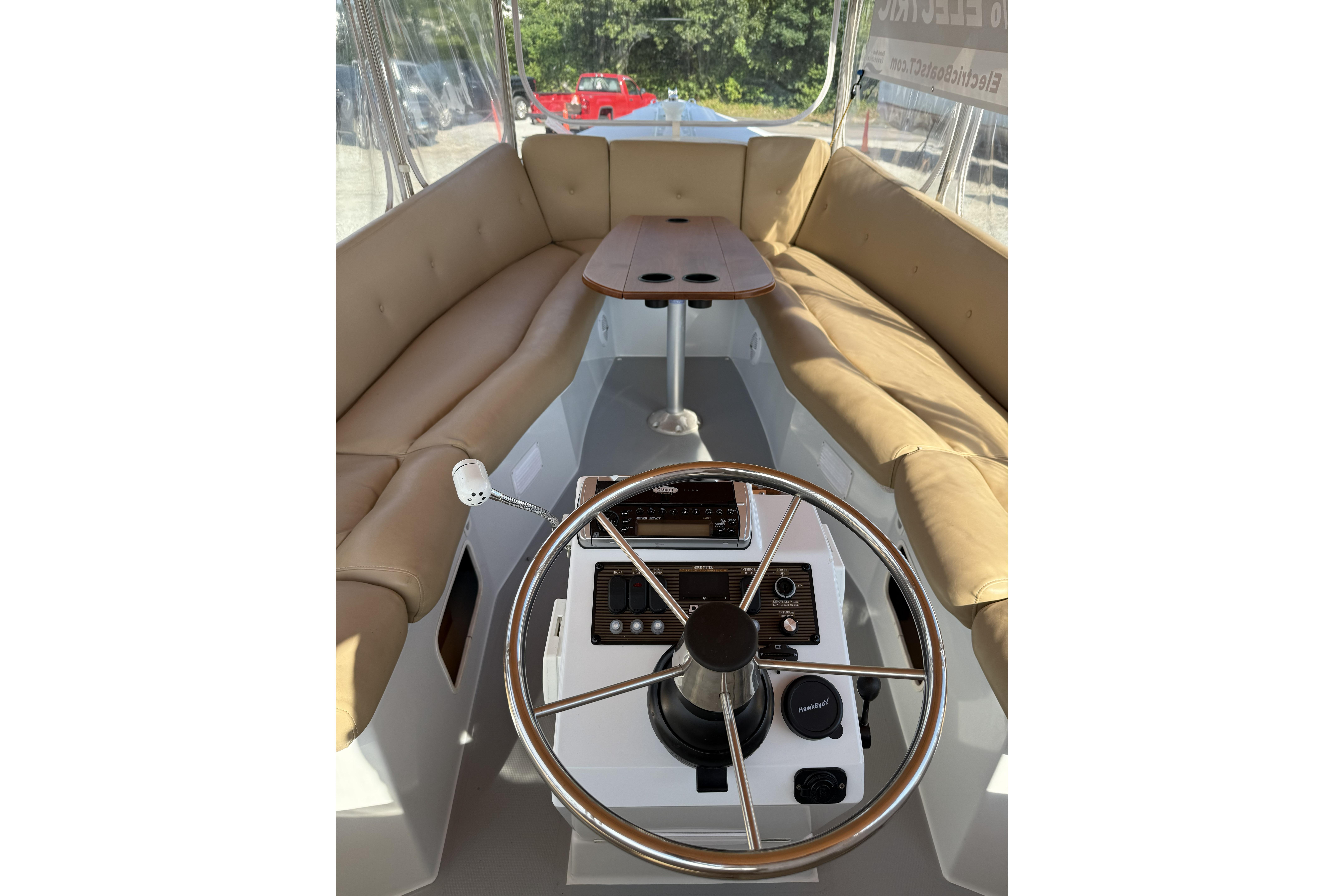 Interior of a 2004 Duffy 21 Classic boat with tan seating and steering wheel.