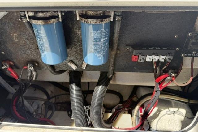 2006 Sailfish 2660 CC boat engine compartment with filters and wiring.