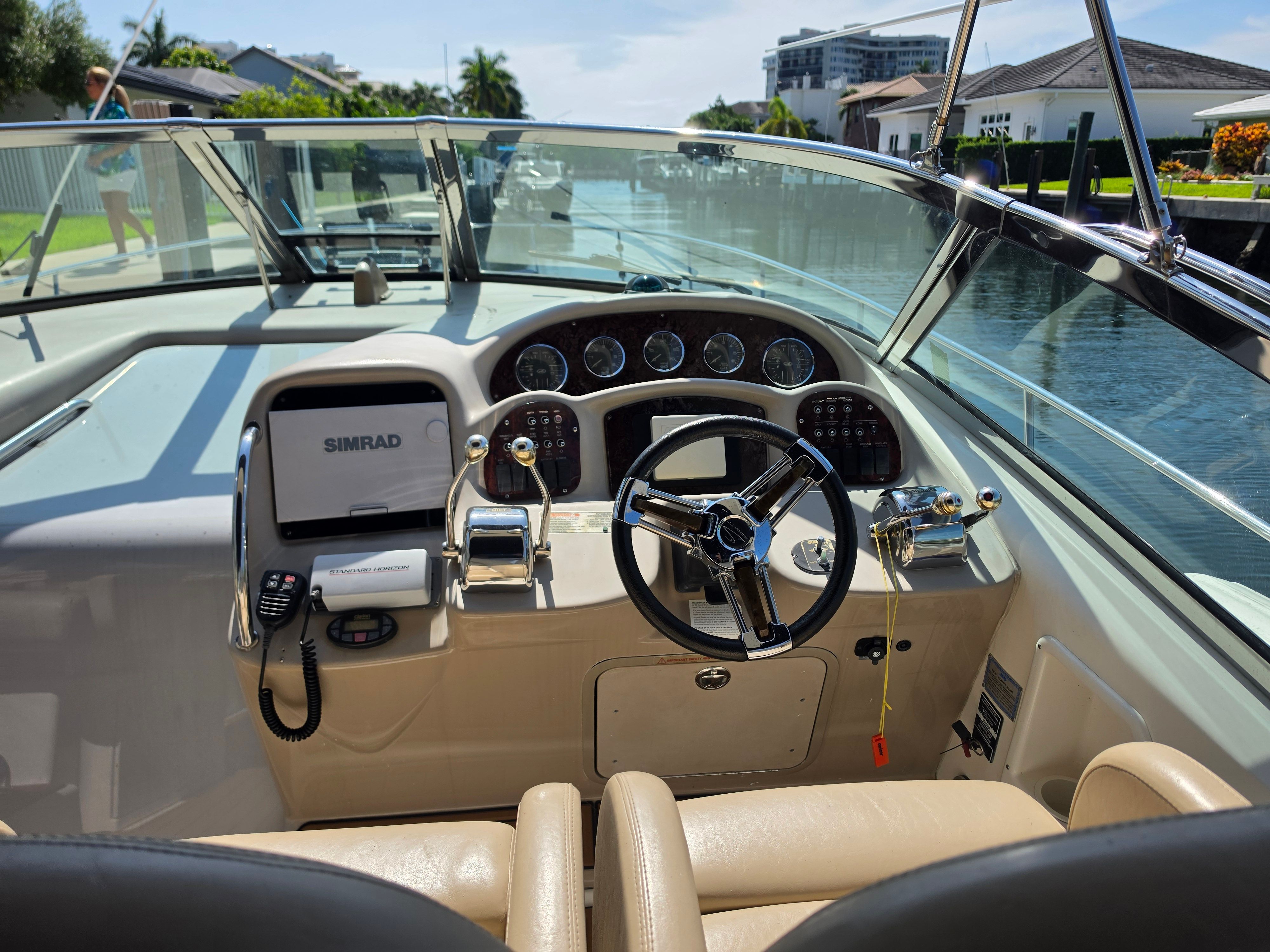 The cockpit of a 2004 Sea Ray 340 Sundancer with steering wheel and instruments.