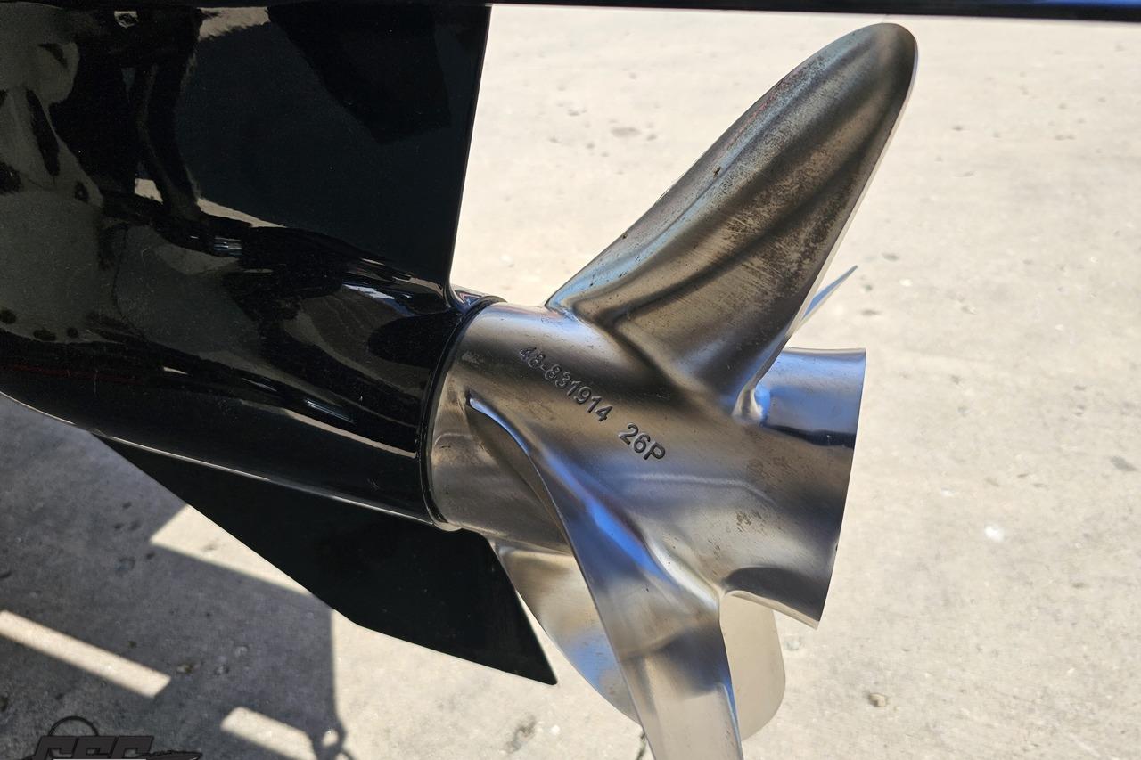 Close-up of a 2014 Formula 292 FASTech boat propeller on a concrete surface.