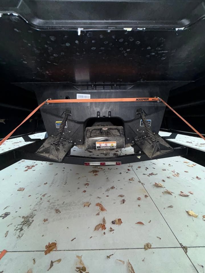 Underside of a Sea-Doo Switch Cruise Limited 21 with trailer and leaves on the ground.
