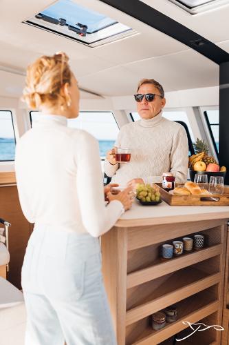 Couple enjoying breakfast on Nautitech 44 Open yacht, 2025 model.
