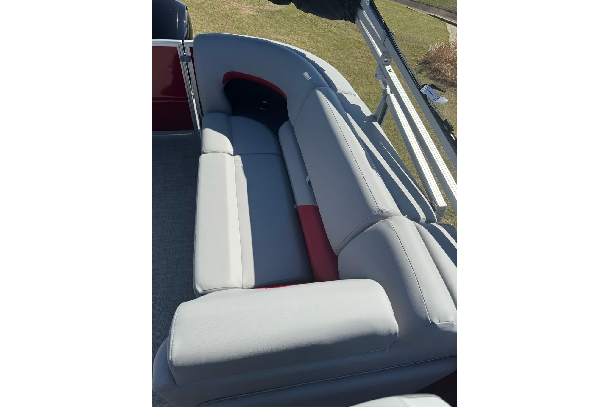 2026 Sun Tracker Party Barge 22 XP3 interior seating with gray and red upholstery.
