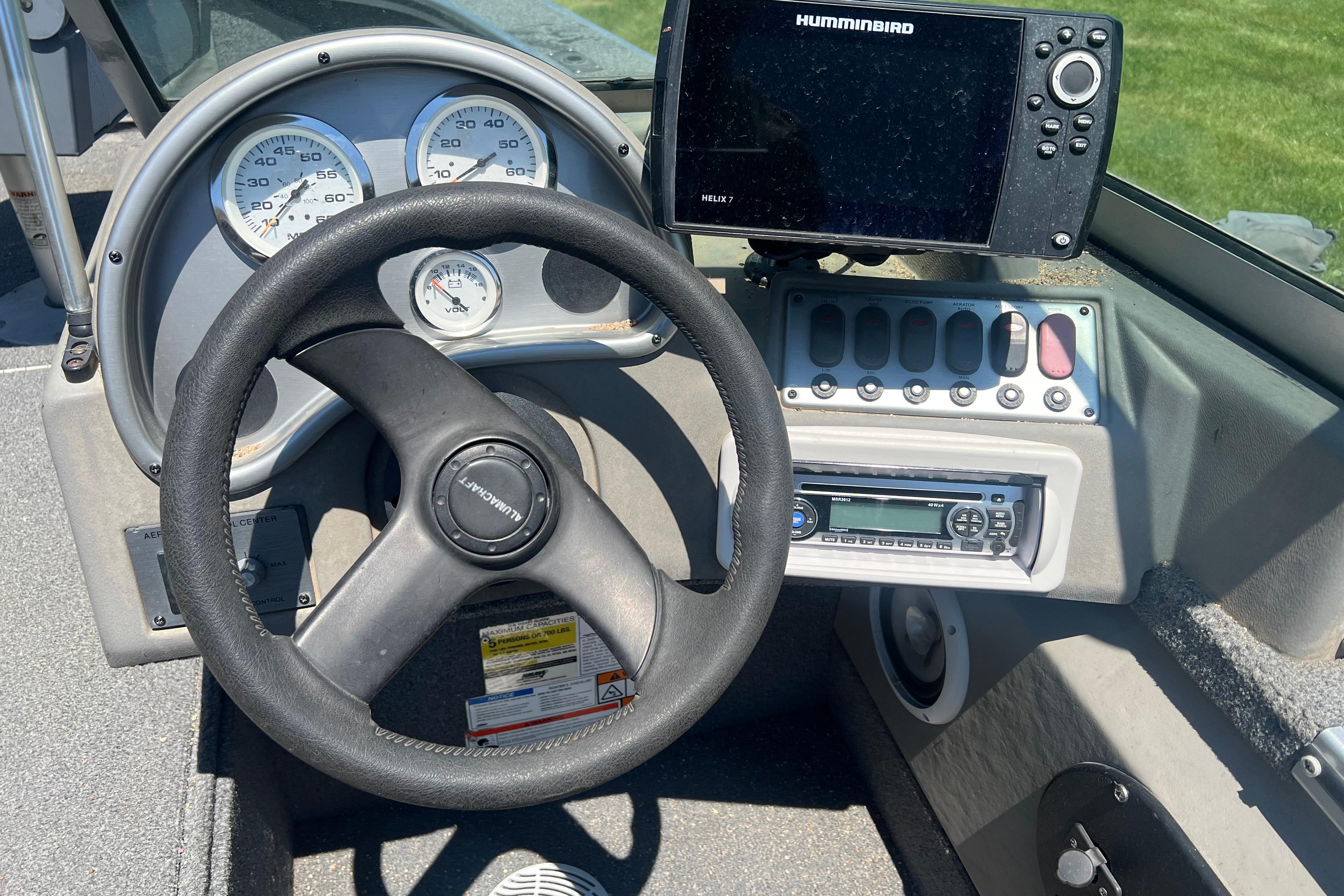 Steering wheel and dashboard of 2010 Alumacraft Dominator 165 Sport boat with Humminbird display.