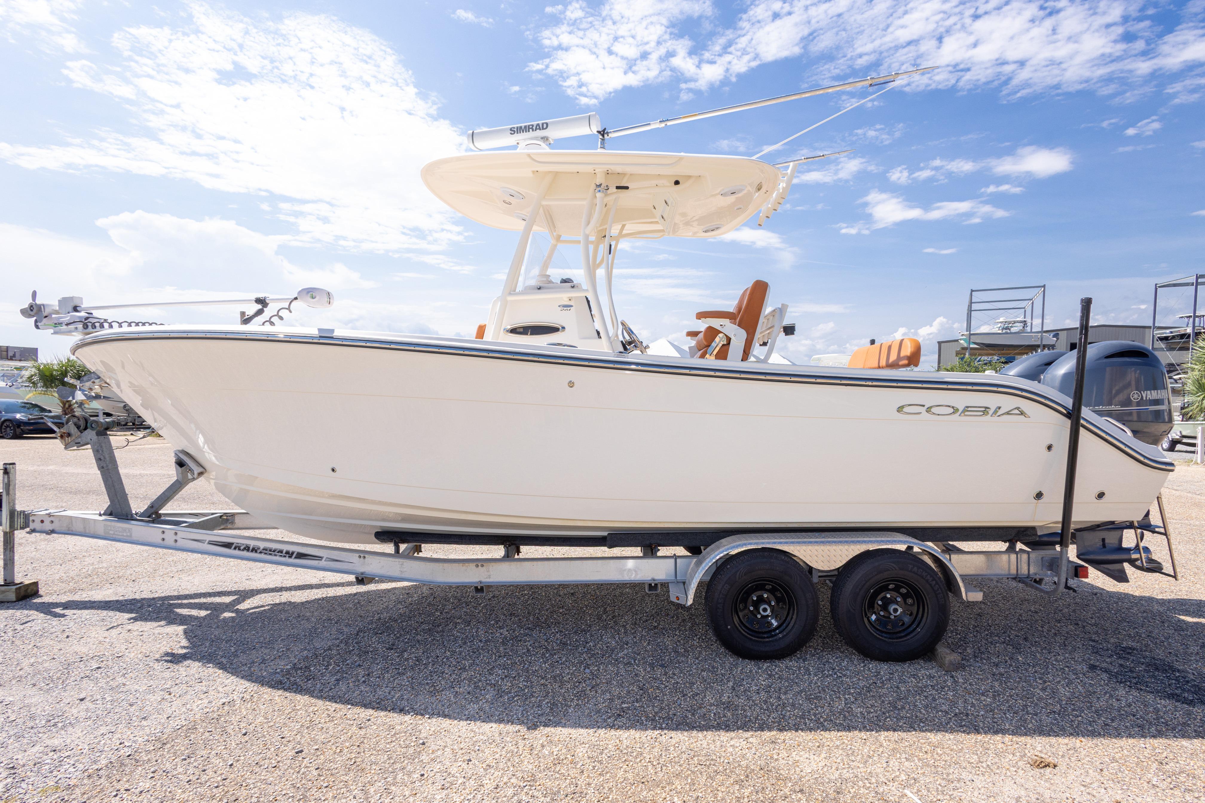 2017 Cobia 261 Center Console boat on trailer under clear blue sky.