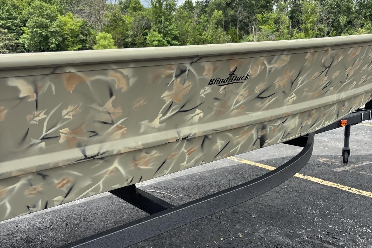 2025 Tracker Grizzly 1648 Jon boat with camo design on a trailer.
