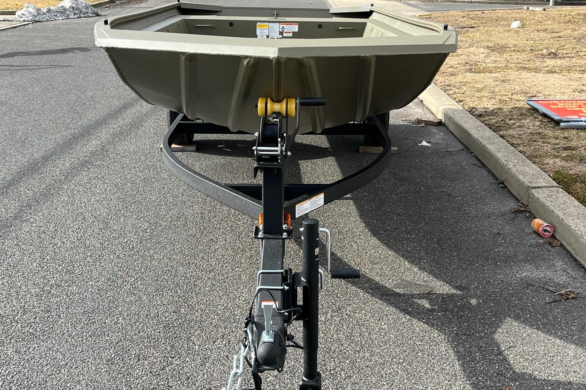 2026 Tracker Grizzly 1754 Utility boat on trailer, parked on asphalt road.