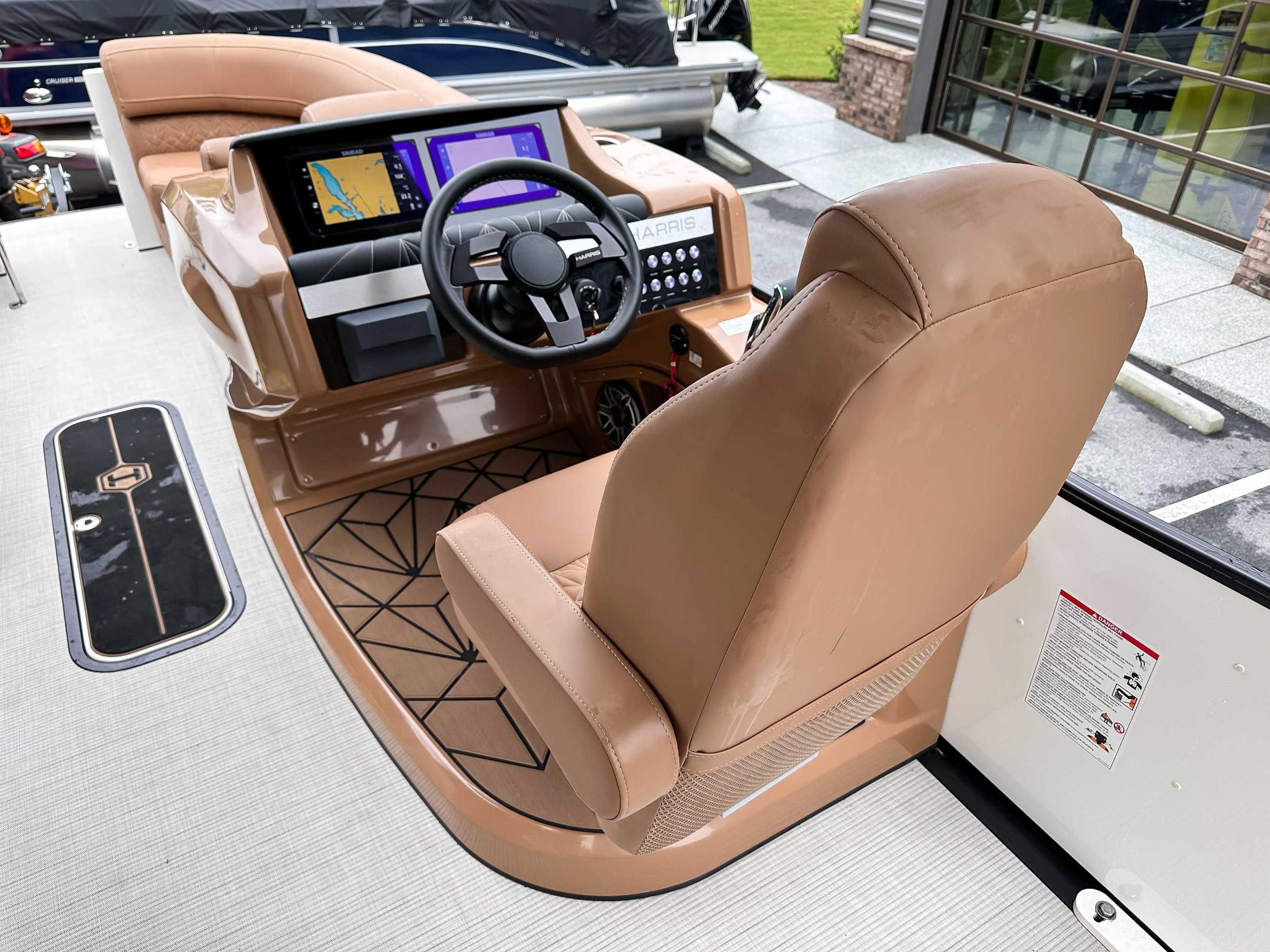 Interior of 2025 Harris Grand Mariner 230 SLDH with modern helm.
