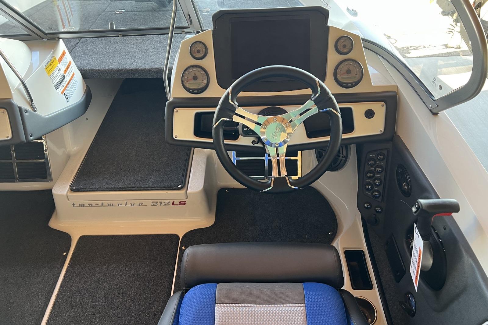 Interior view of 2025 Ranger 212LS boat cockpit with steering wheel and dashboard controls.
