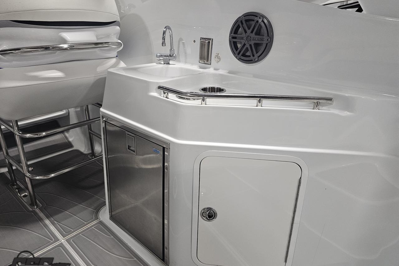 2008 Baja 335 Performance boat interior with sink, speaker, and seating area.