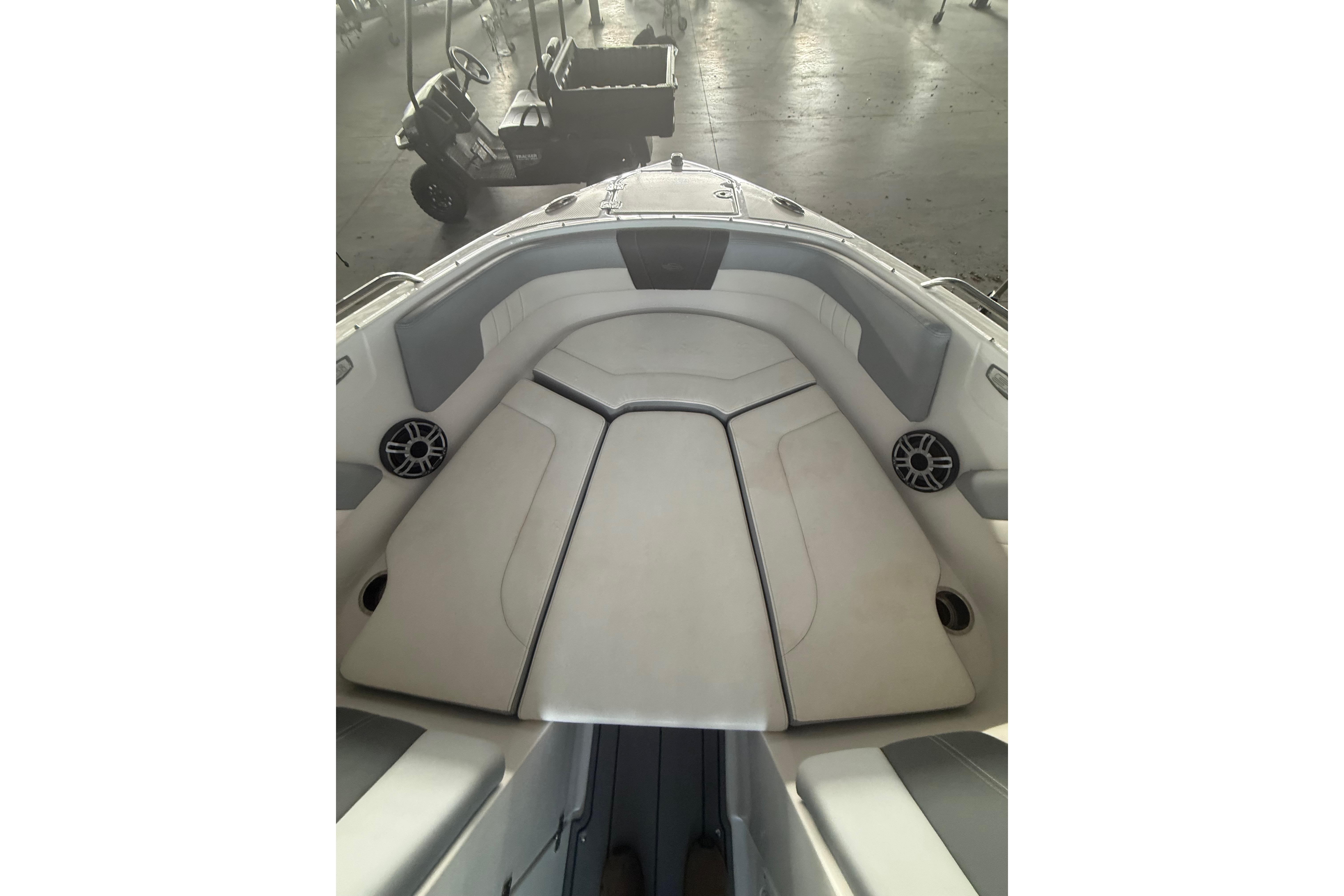 2023 Chaparral 230 SSi boat interior with cushioned seating and speakers.