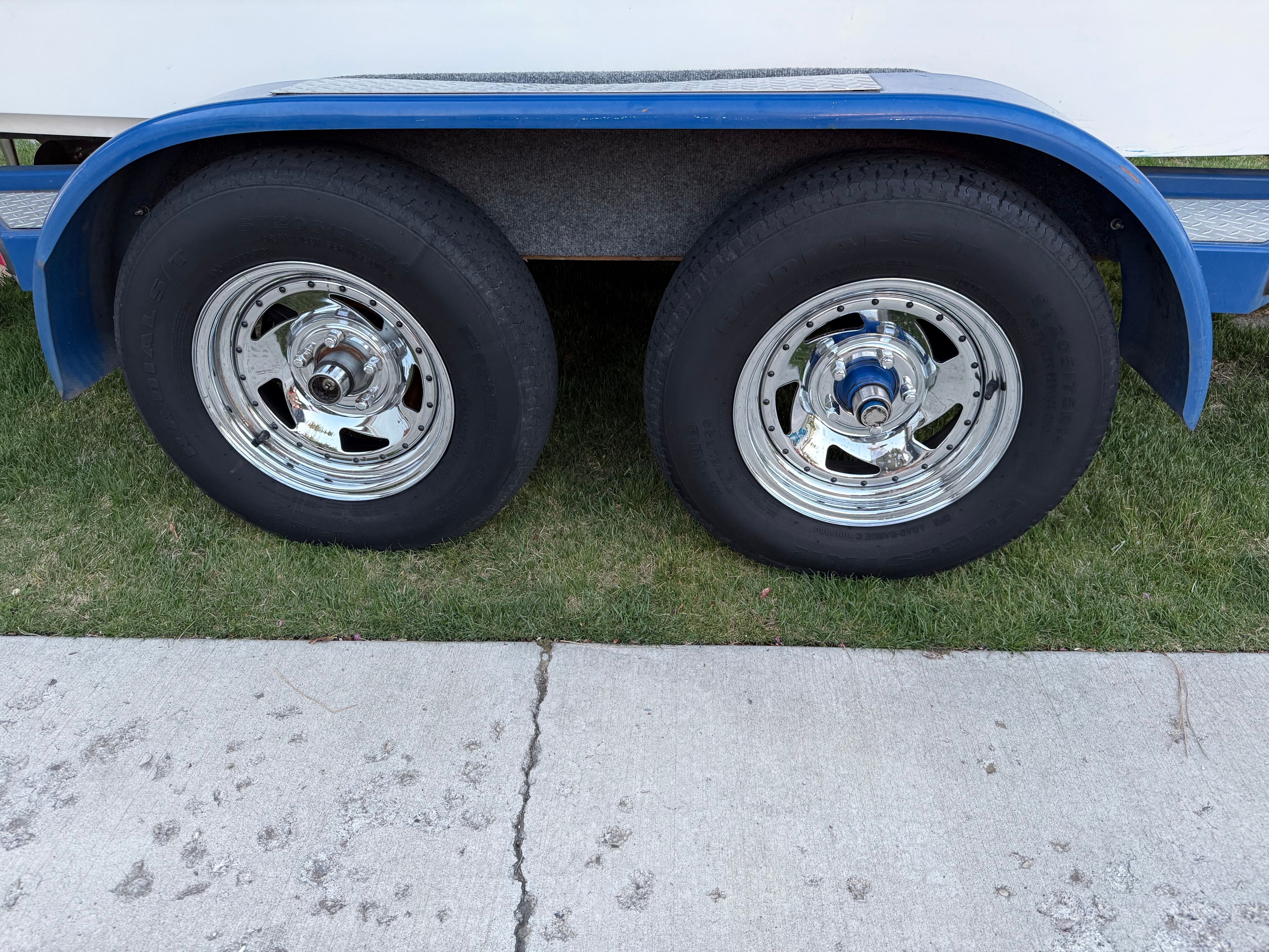 Dual wheels of a 2004 MB Sports 220 boat trailer.