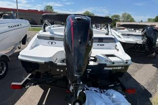 2026 Tahoe T18 boat with outboard motor, parked on a trailer in a sunny lot.