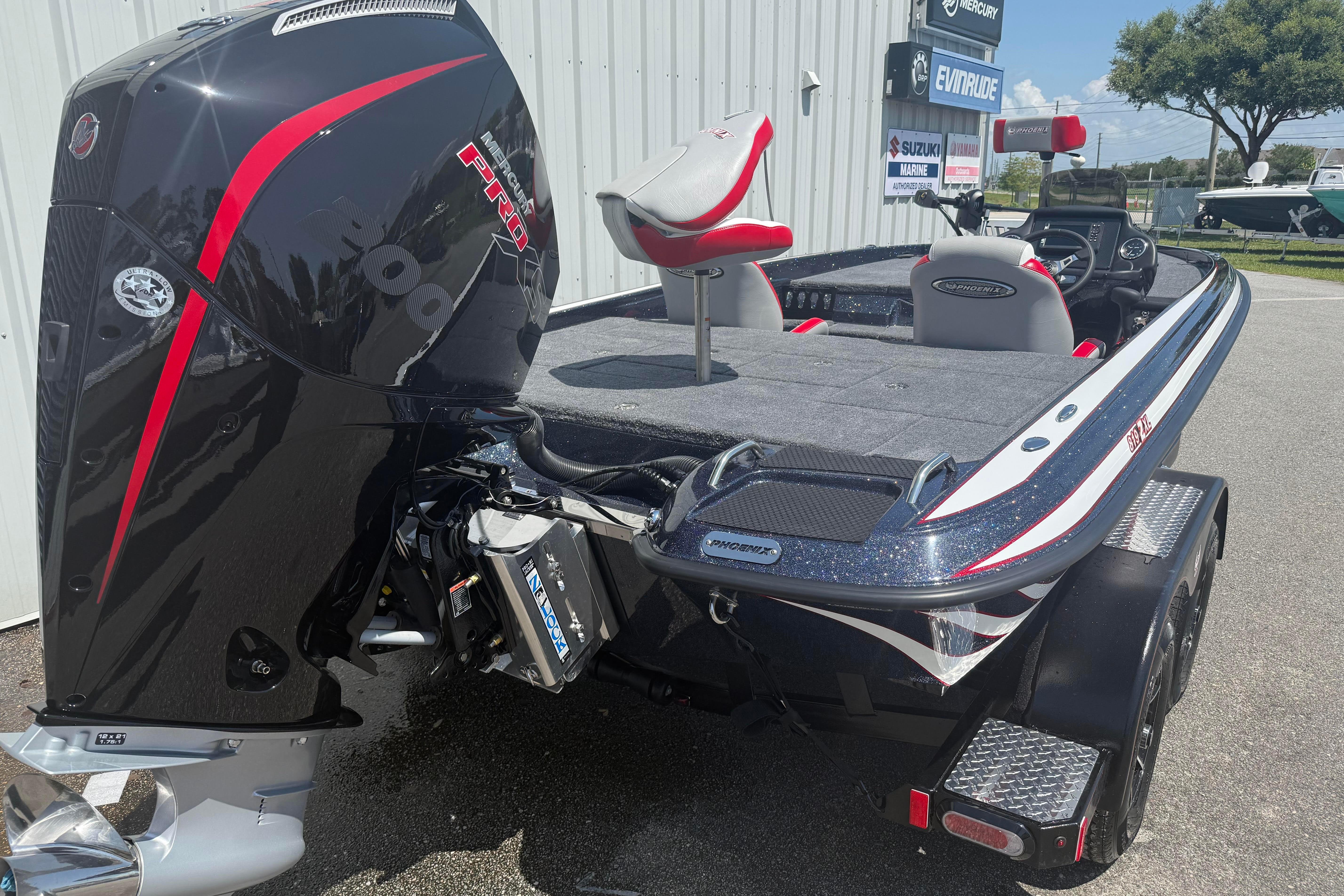 2027 Phoenix 819 ZXL boat with powerful Mercury Pro engine, parked outdoors.