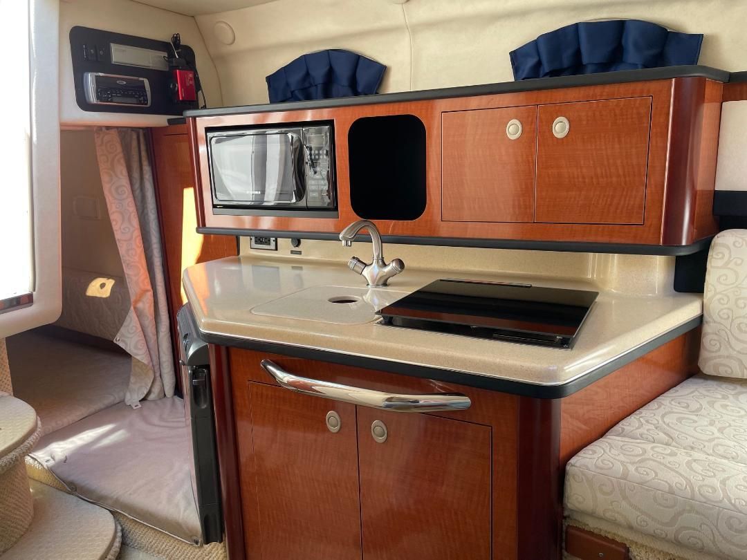 Compact galley in a 2005 Sea Ray Sundancer 260 with microwave and sink.