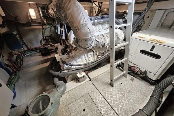 Engine room of a 2005 Sunseeker Manhattan 66 yacht, featuring machinery and ladder.