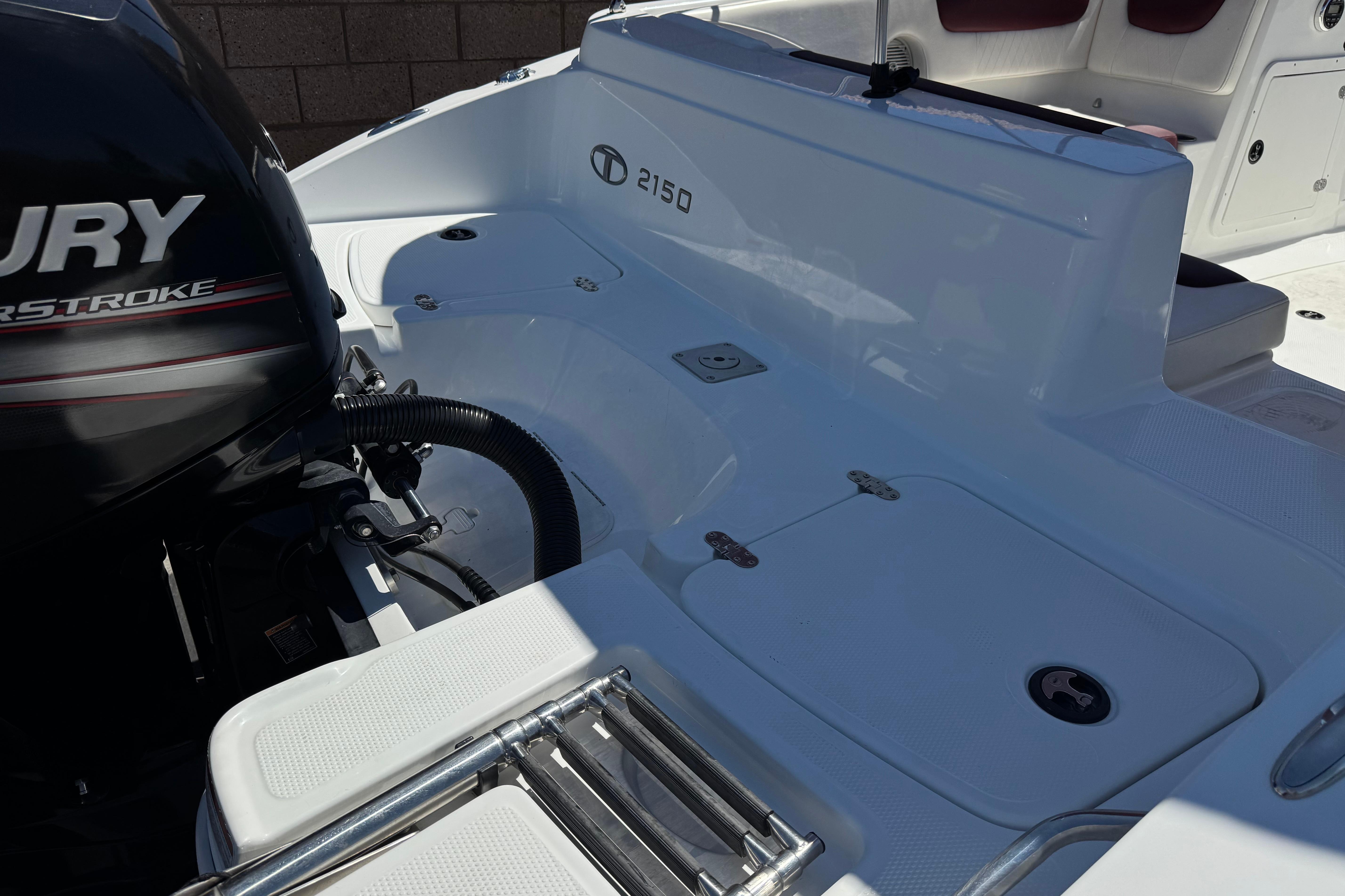 2017 Tahoe 2150 boat deck with Mercury outboard motor, featuring sleek white design.
