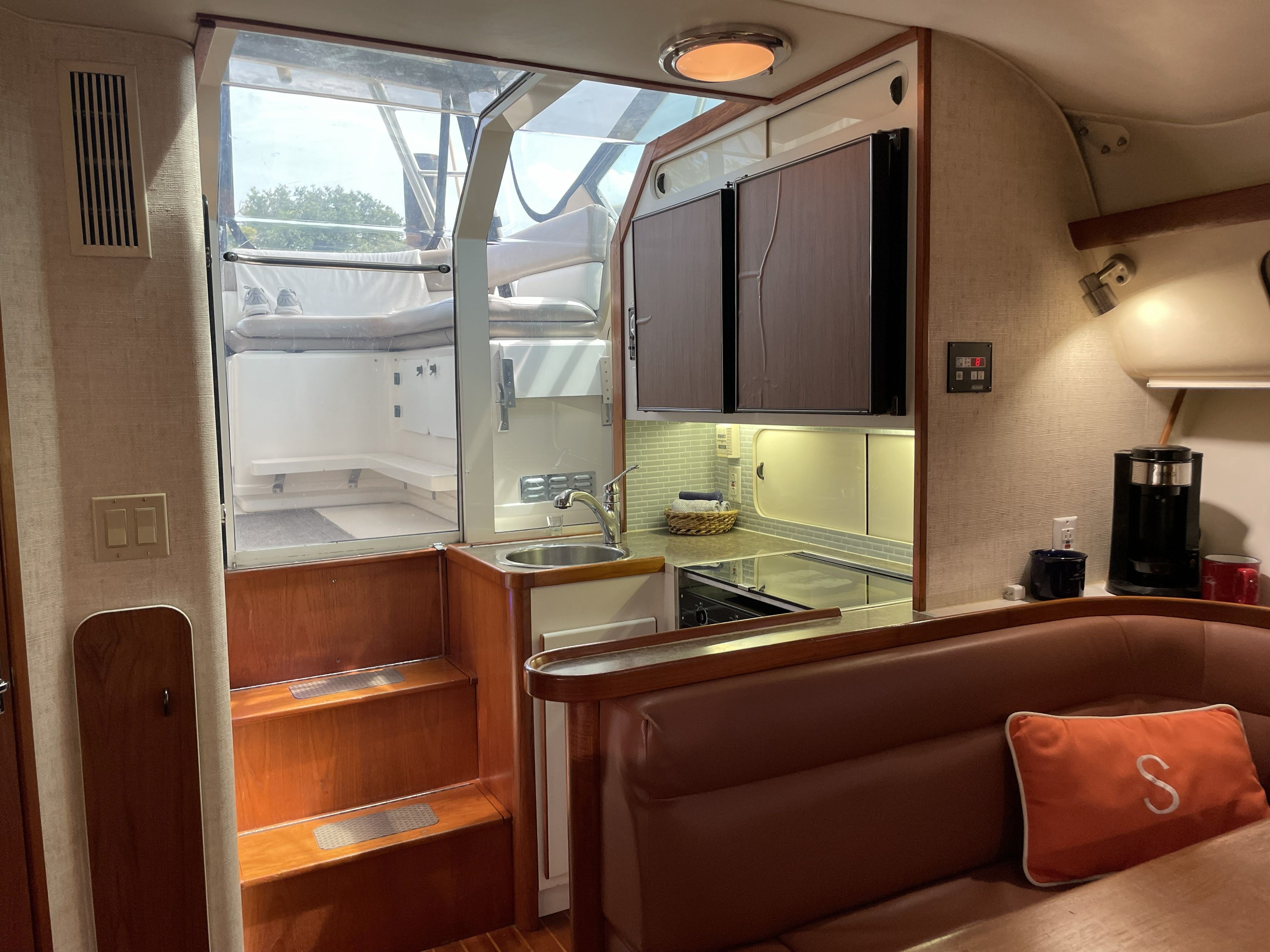 Interior of a 1994 Tiara Yachts 3600 Open with a kitchen and seating area.