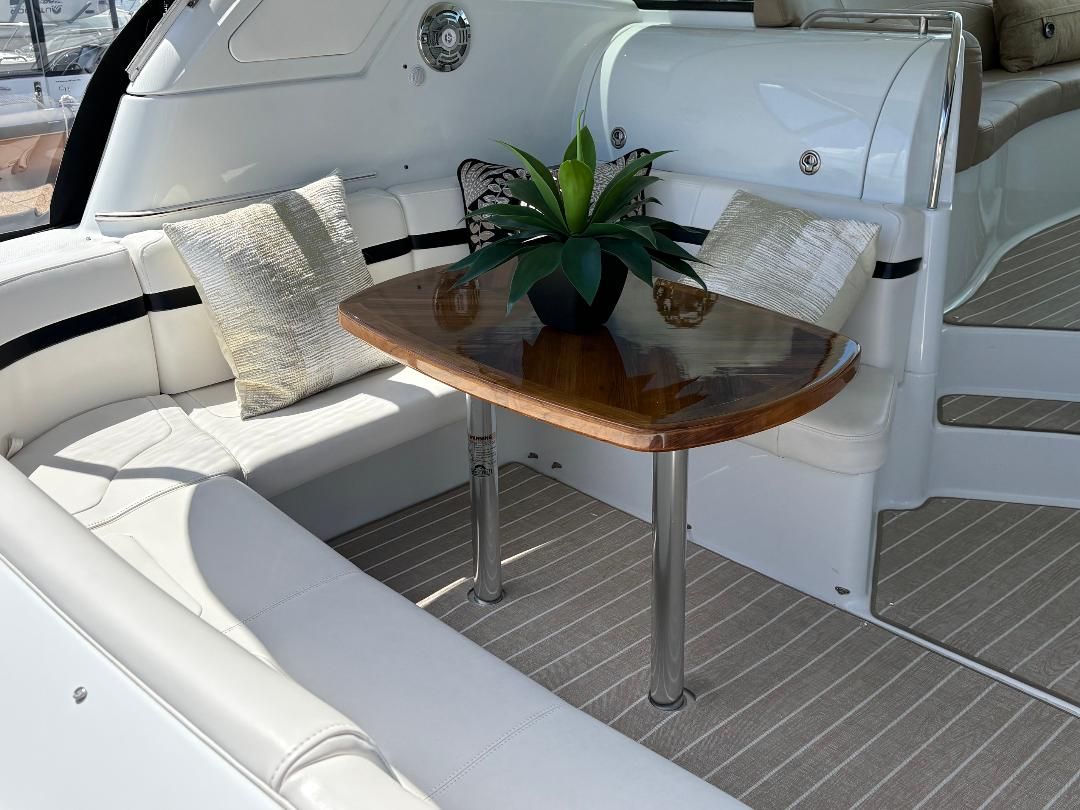 Interior of a 2011 Formula 45 with an elegant seating area, wooden table, and plant decoration.