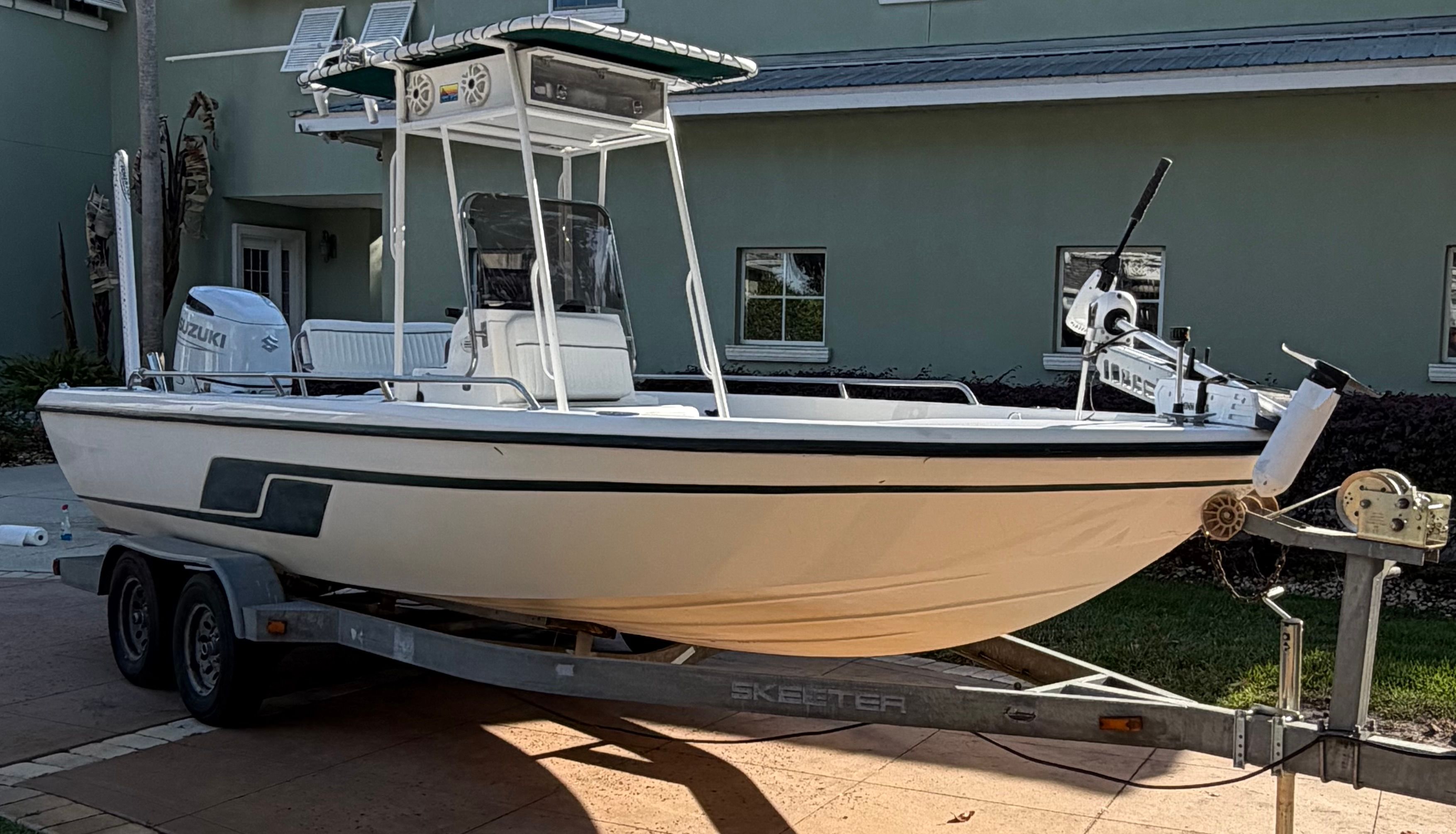 1999 Skeeter ZX2200 boat on trailer in front of building.