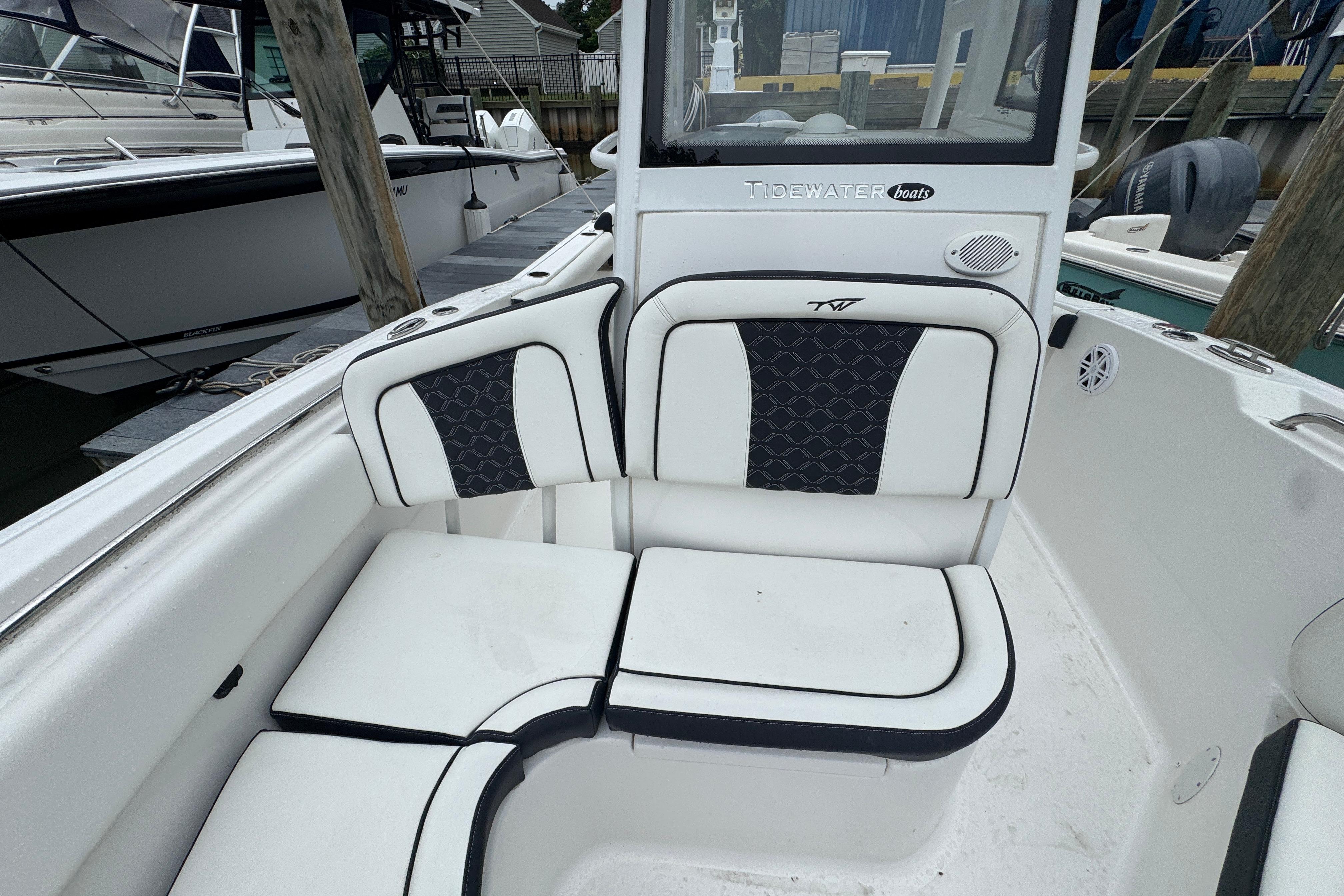 2022 Tidewater 232 SS boat interior with cushioned seating and sleek design.