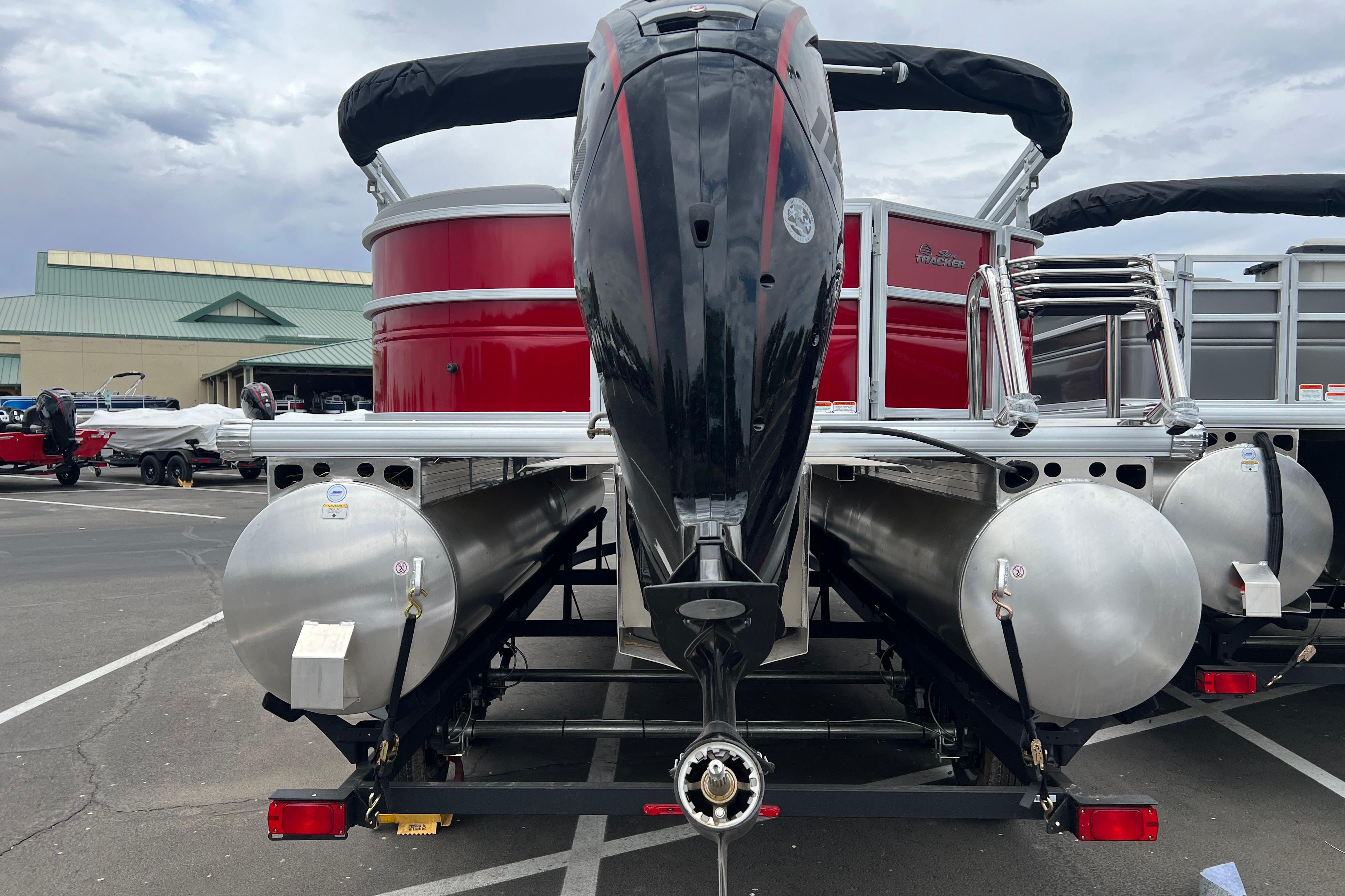 2026 Sun Tracker Party Barge 20 DLX pontoon boat with powerful outboard motor.