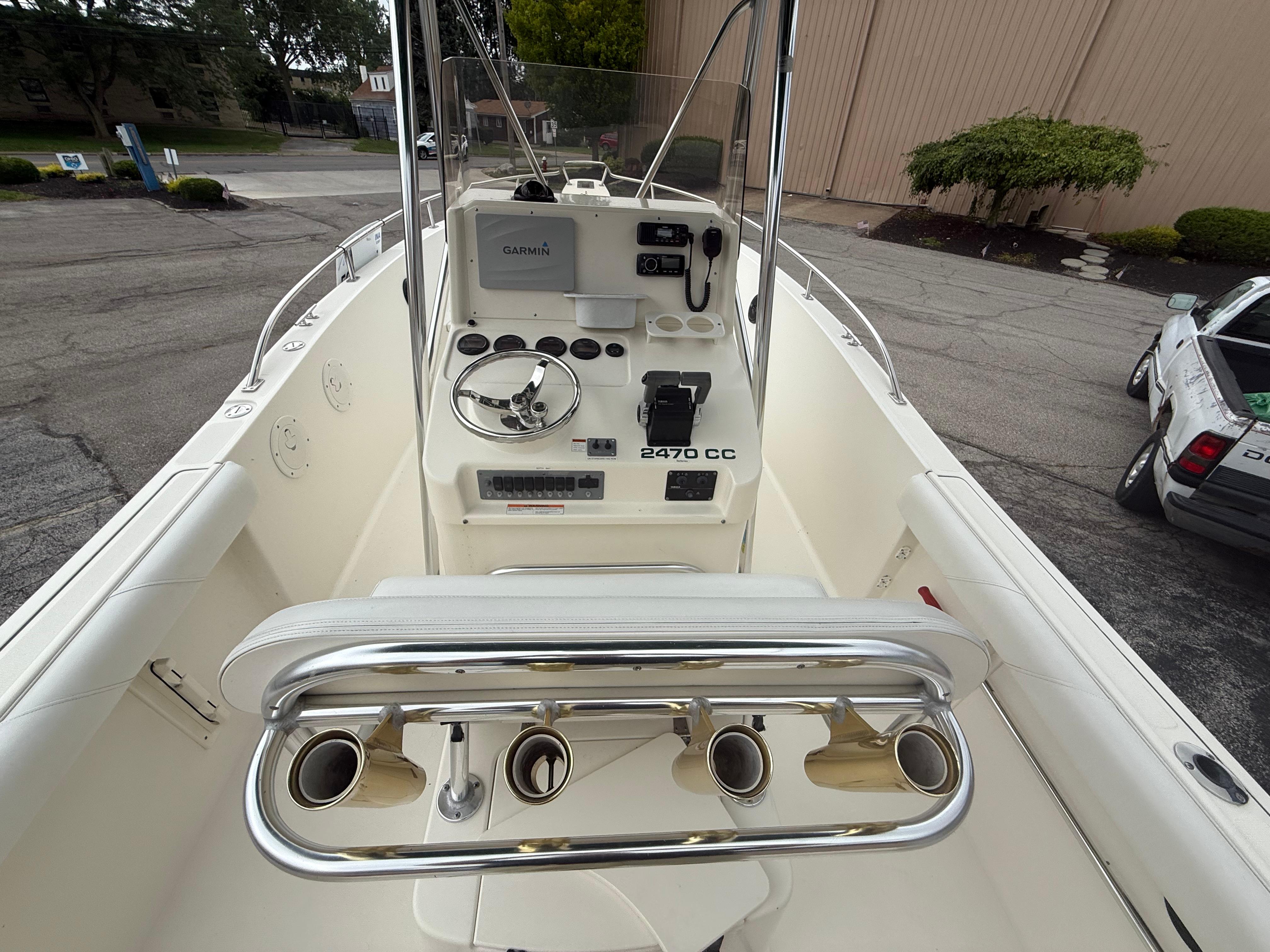 2002 Pursuit 2470 CC boat interior with steering console and rod holders.