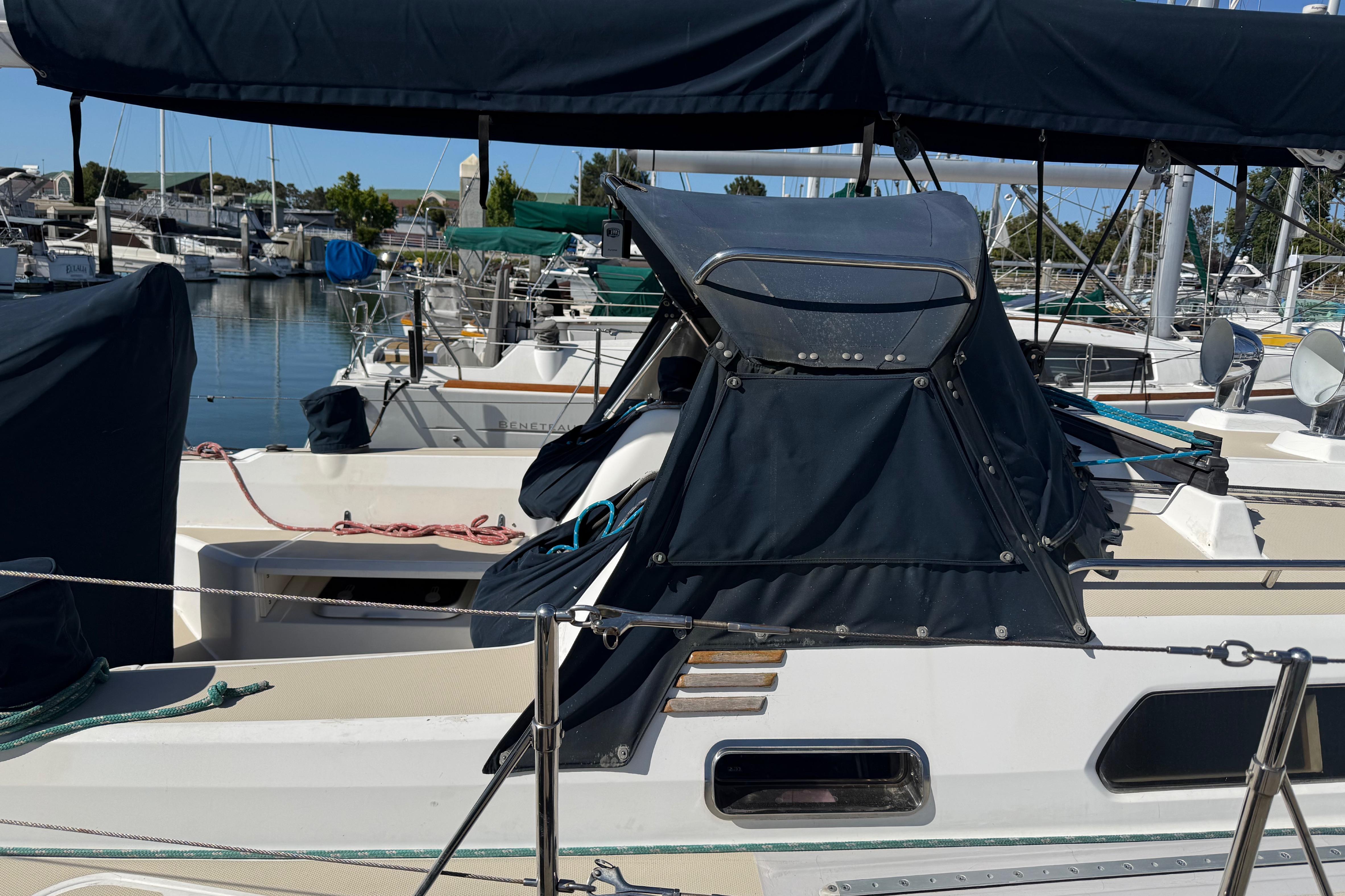 2004 Sabre 386 sailboat docked at marina with covered cockpit and visible rigging.