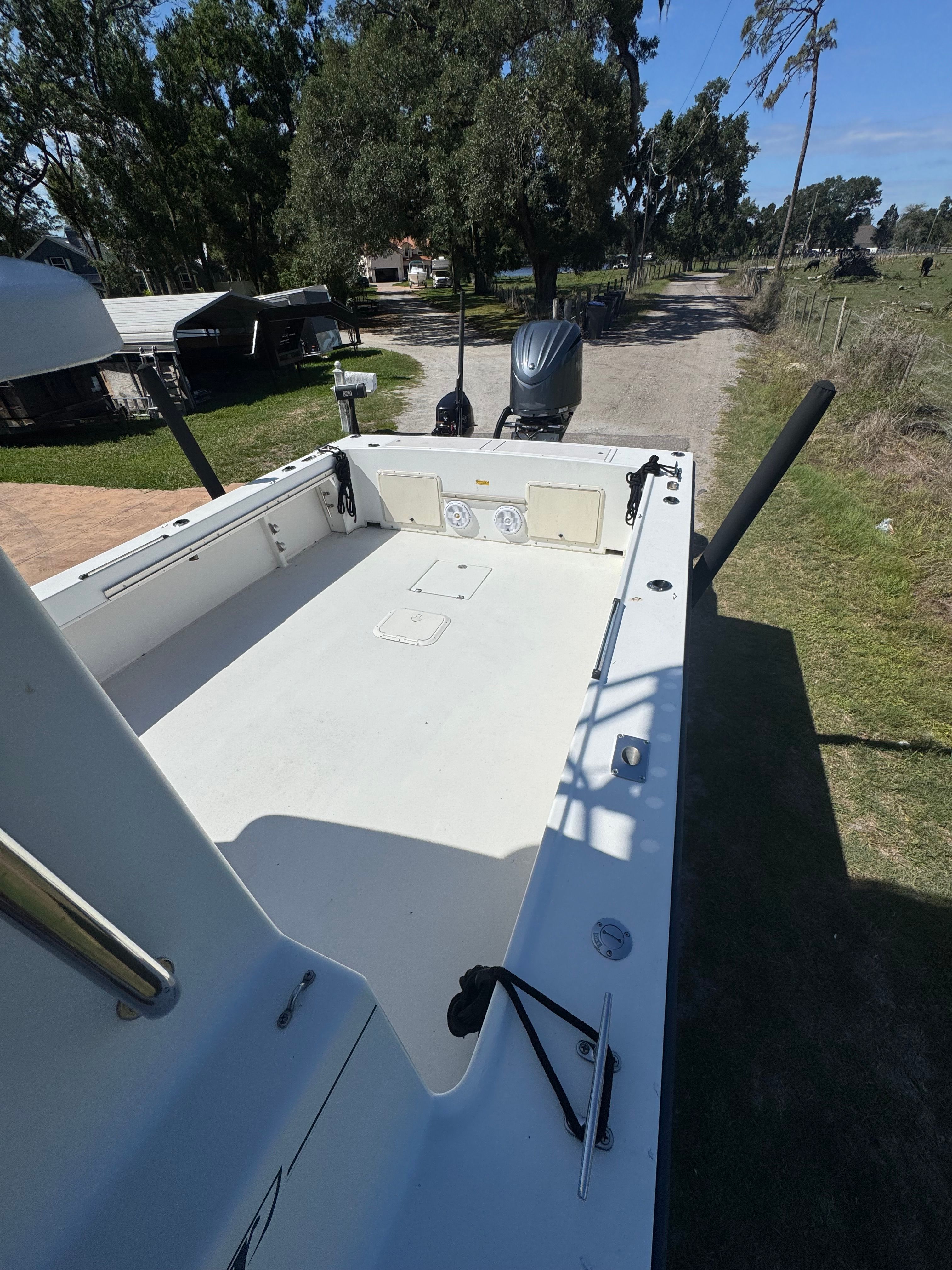 1997 Parker 2520 boat parked on a rural path.