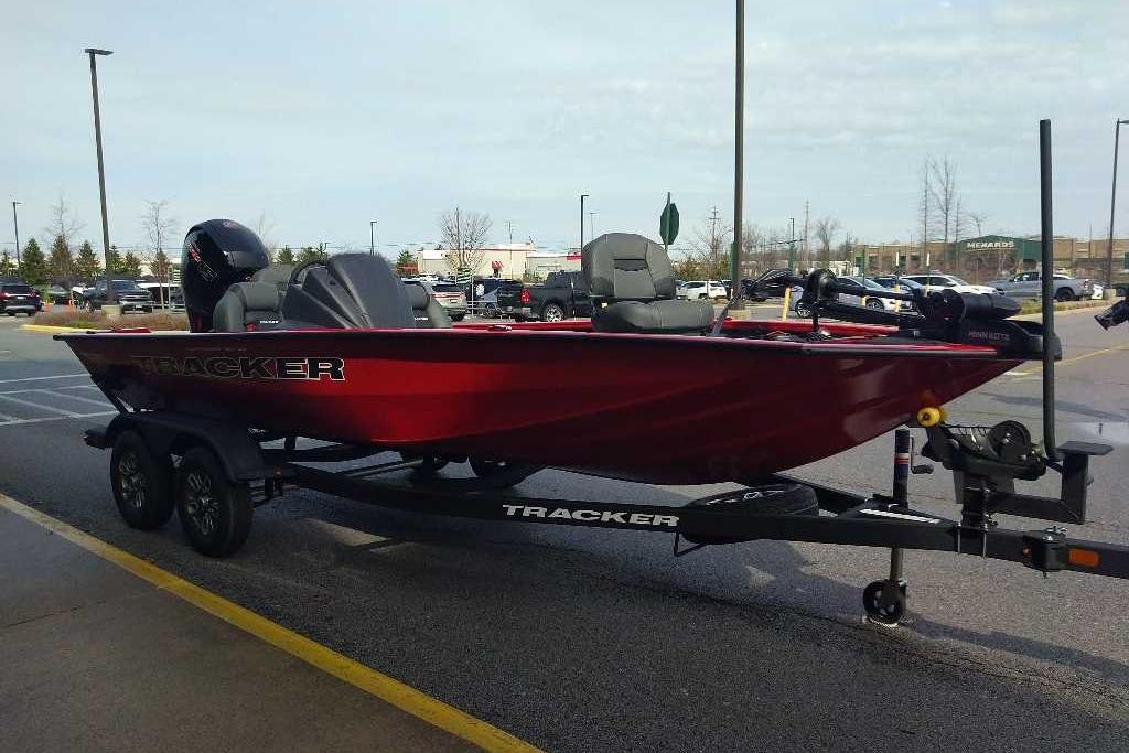 2026 Tracker Pro Team 195 boat on trailer in parking lot.