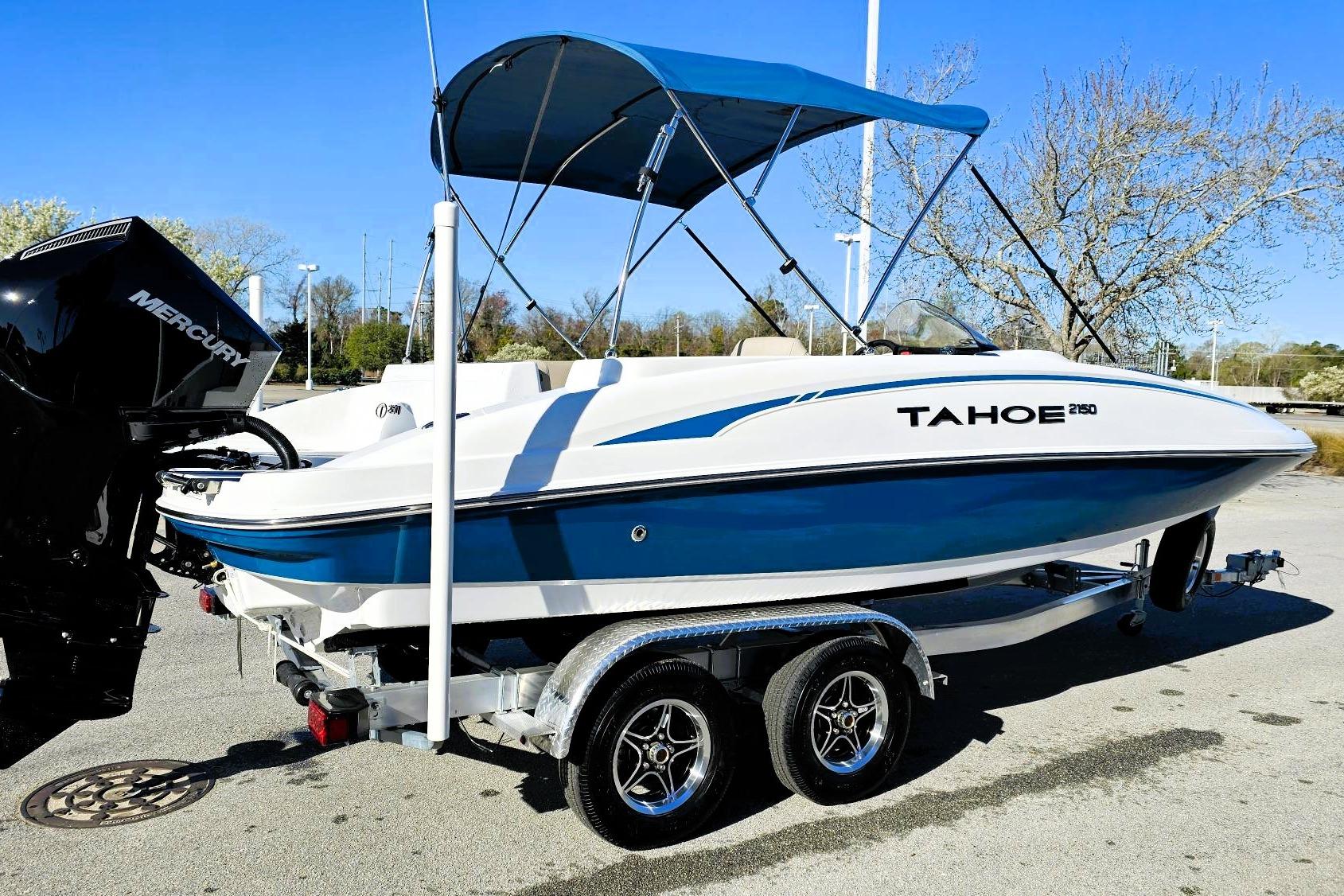 2026 Tahoe 2150 boat with blue accents on a trailer, featuring a Mercury engine.