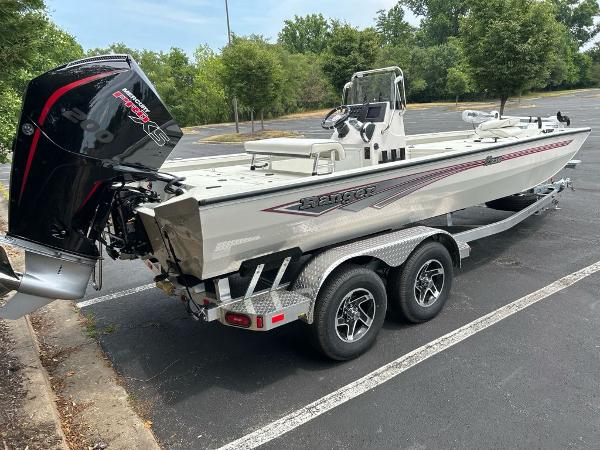 2024 Ranger RB210 boat on trailer in parking lot, featuring powerful outboard motor.