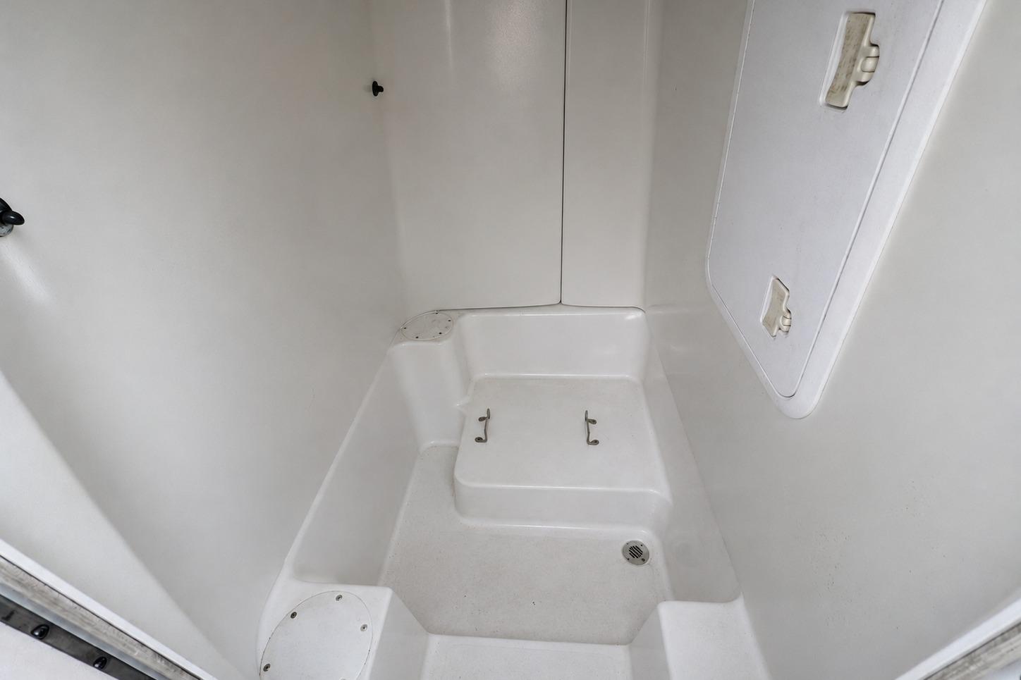 2008 PROLINE 20 Sport boat interior storage compartment with white finish and secure latches.