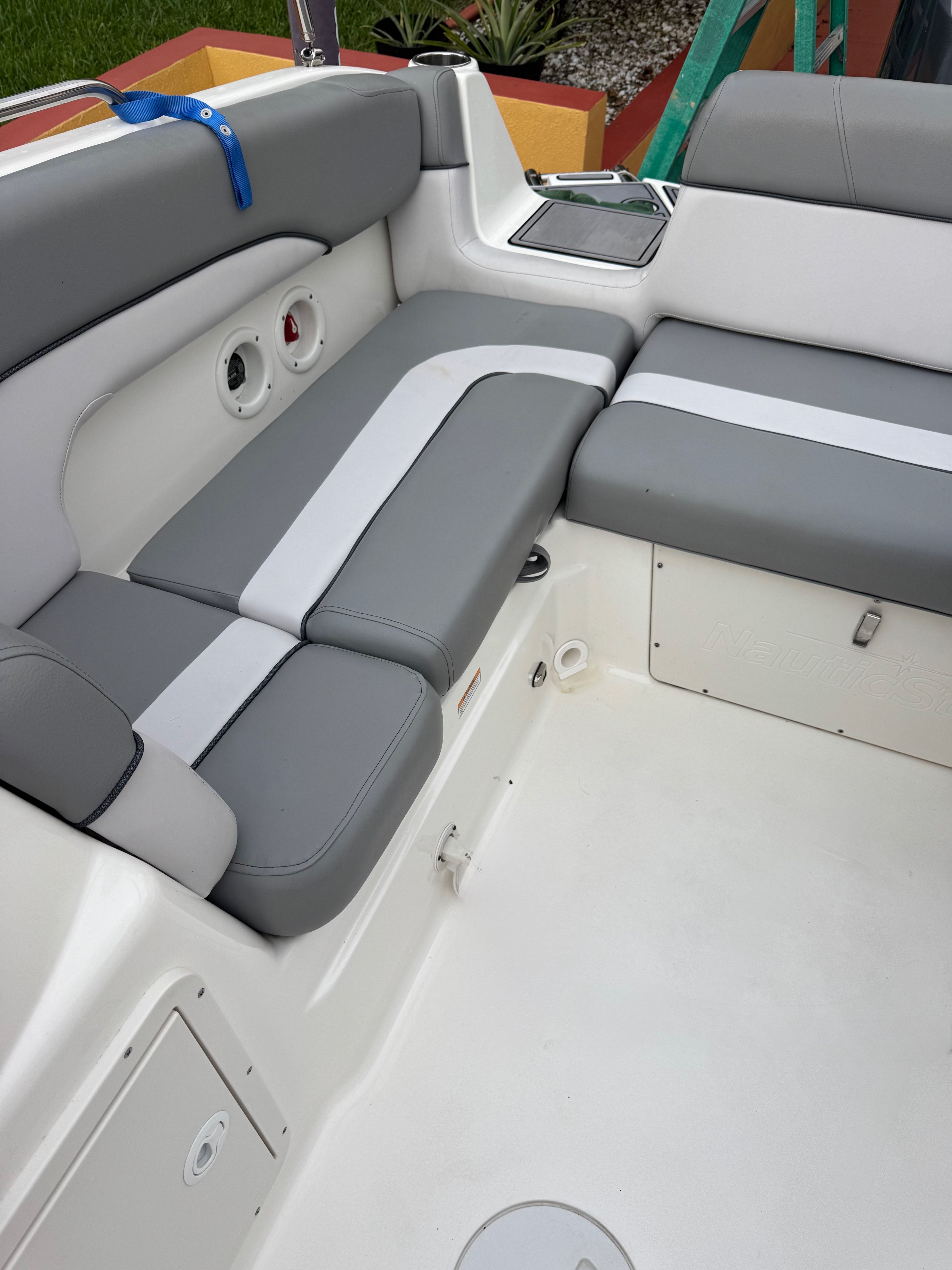 Interior view of a 2022 NauticStar 243 DC featuring gray and white upholstery.