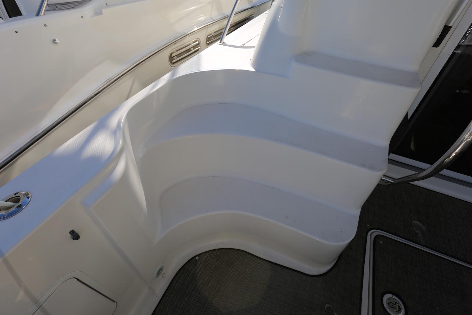 Staircase on 2004 Sea Ray 420 Sedan Bridge yacht, featuring sleek white design.