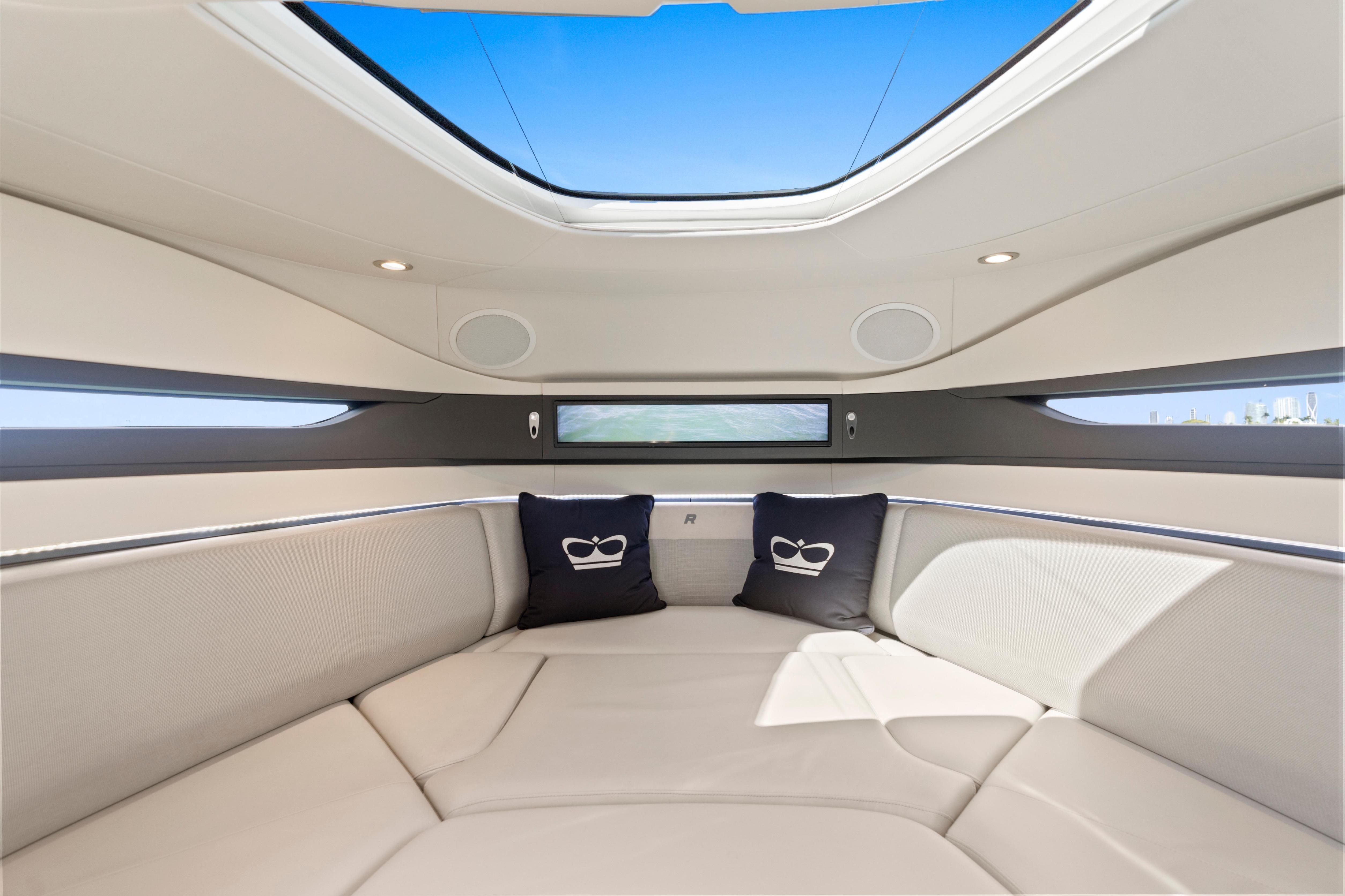Luxurious interior of 2020 Princess R35 yacht with skylight and plush seating.