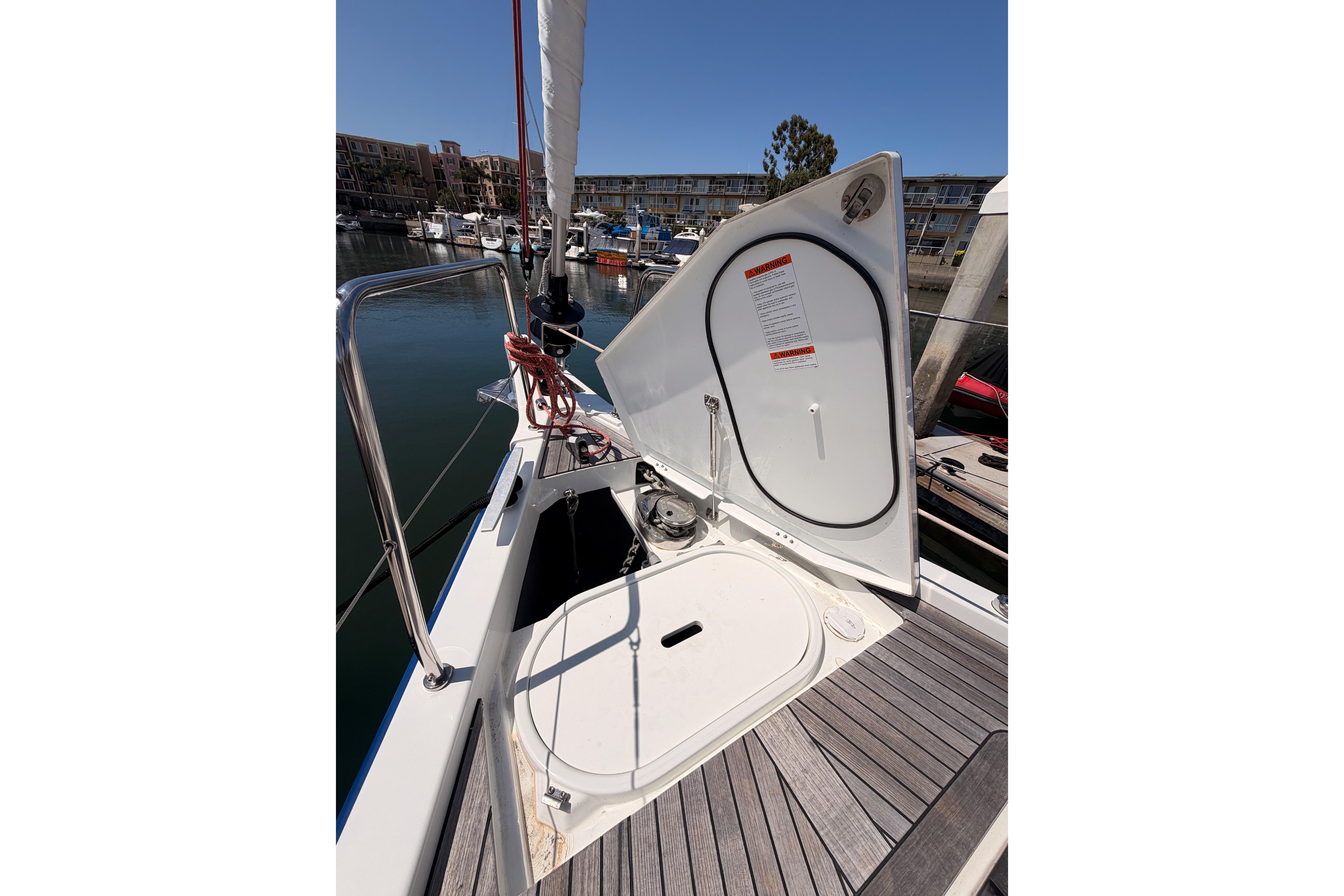 Open hatch on 2022 Beneteau Oceanis Yacht 54, docked in marina.
