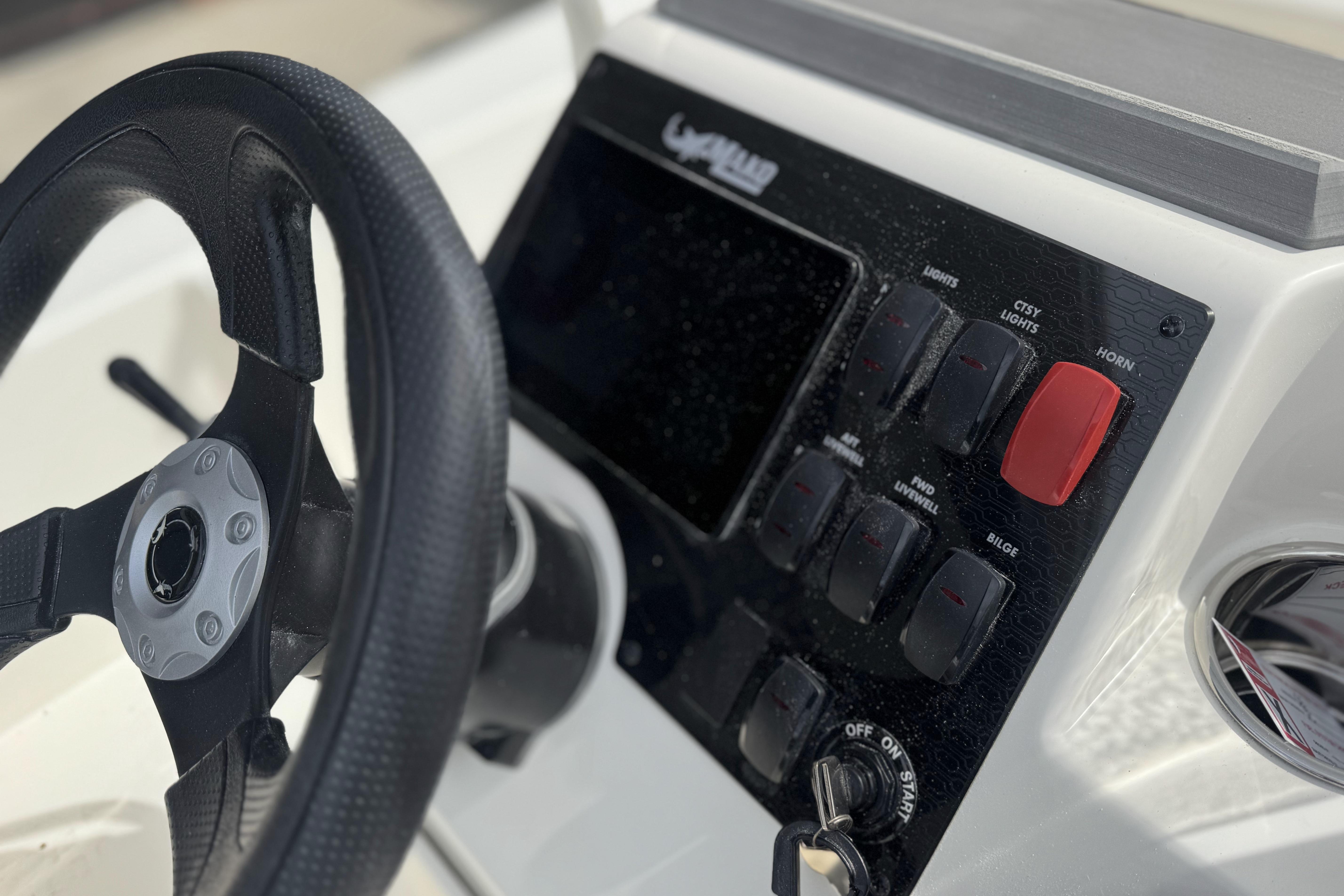 Steering wheel and control panel of 2026 Mako 18 Pro Skiff boat.