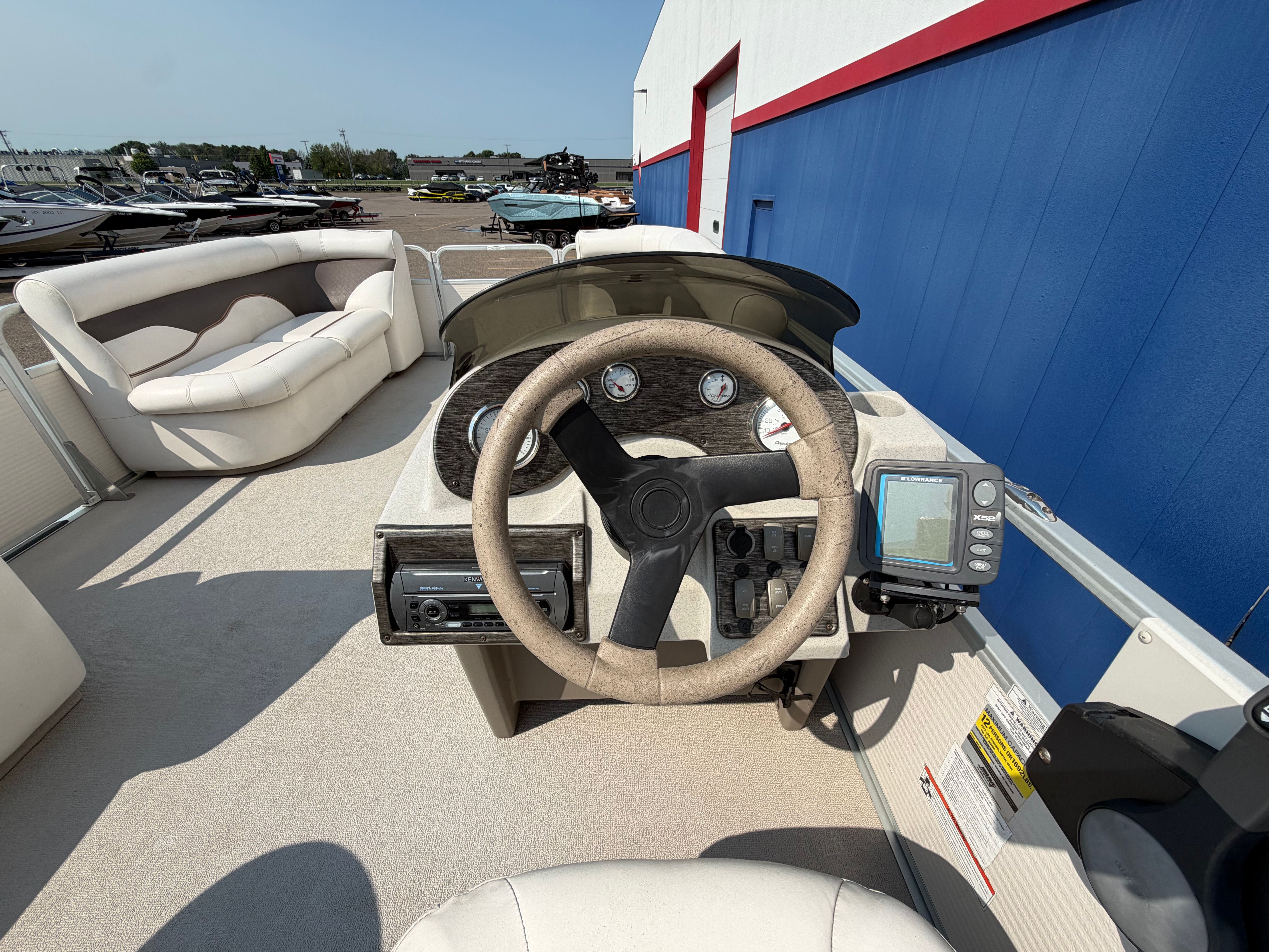 The image shows the helm of a 2007 Premier 225 Sunsation with a steering wheel and gauges.