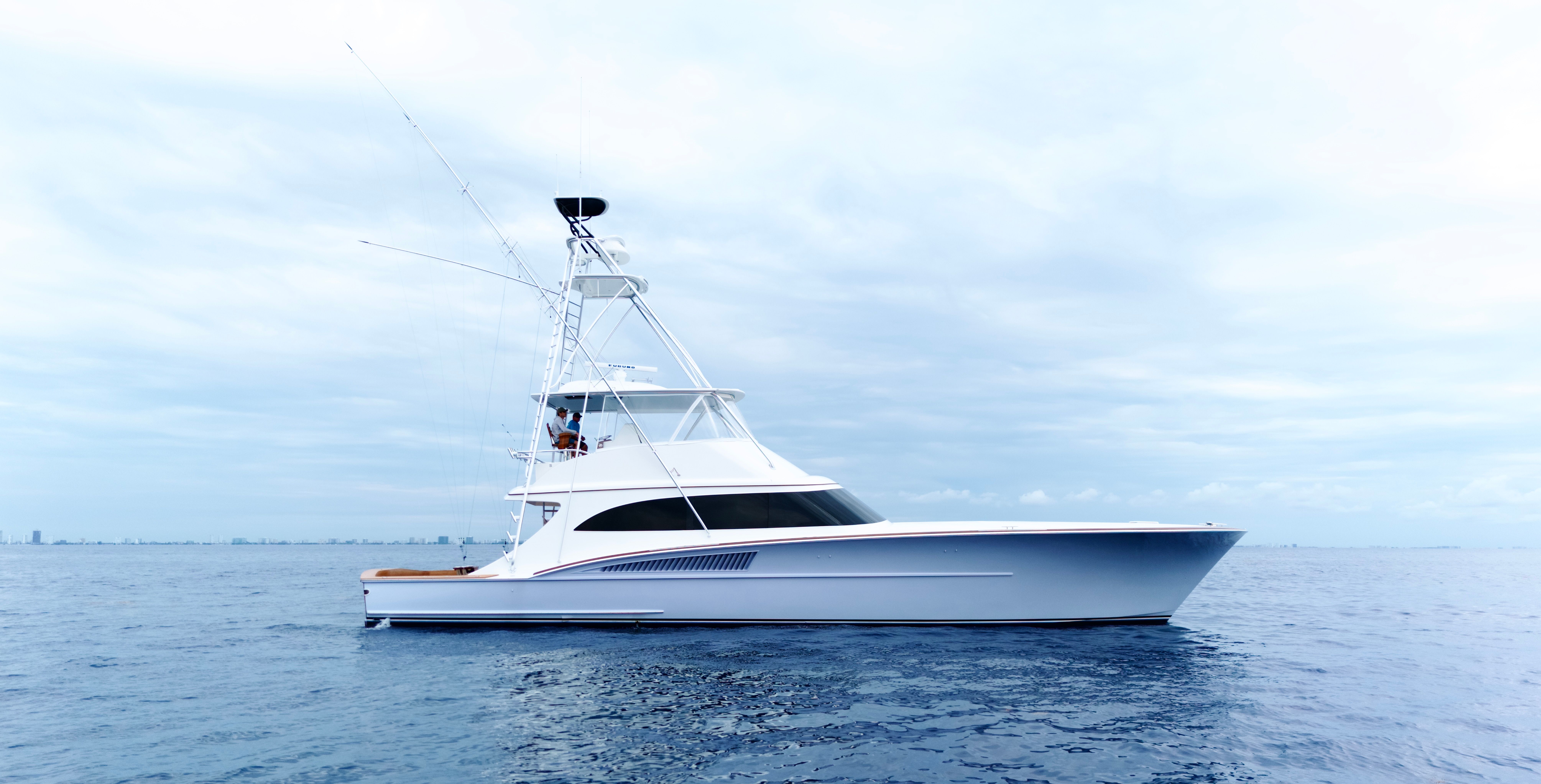 A sleek 2025 Titan Yachts sportfish boat on calm waters.