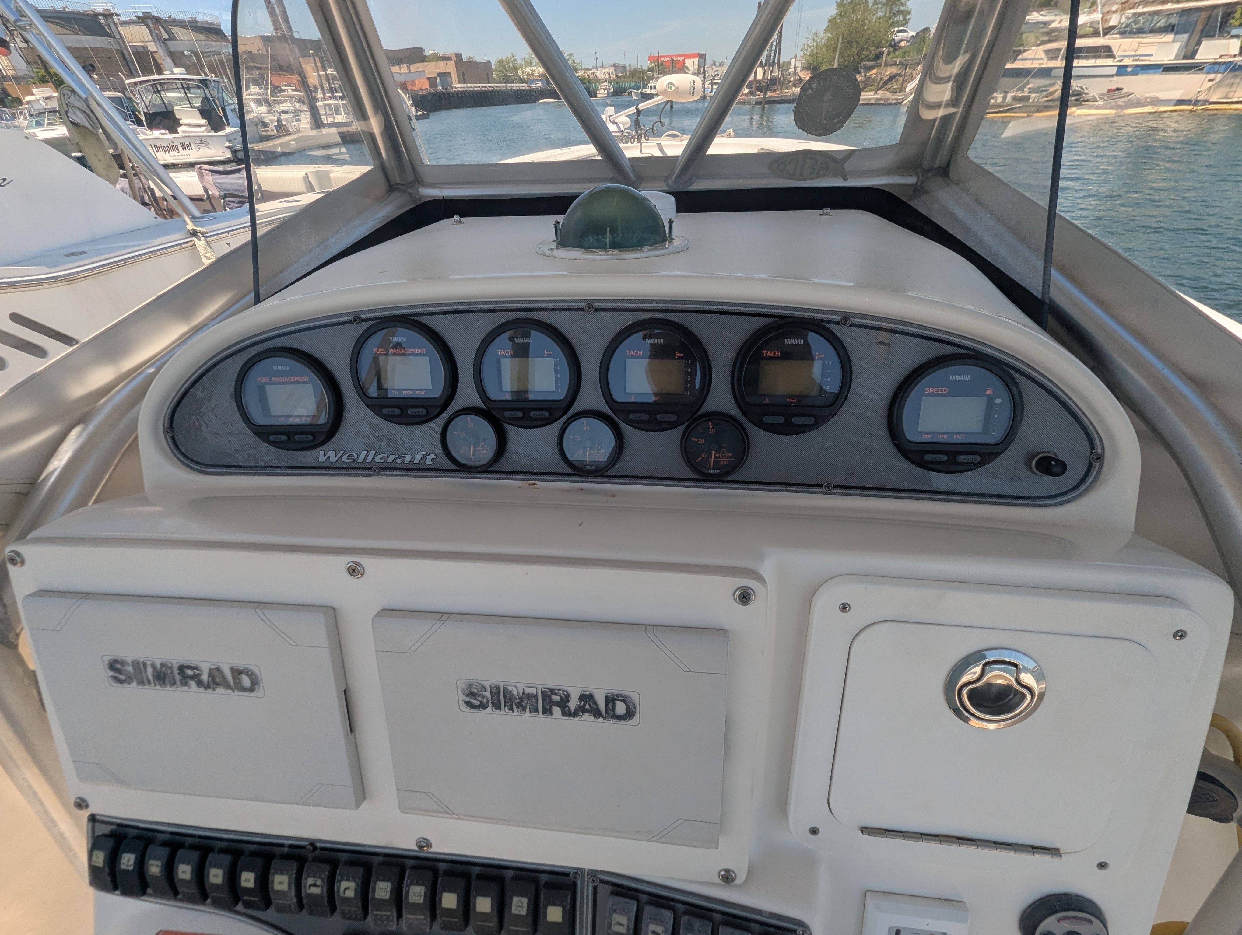 Dashboard of a 2005 Wellcraft 35 CCF boat in harbor.